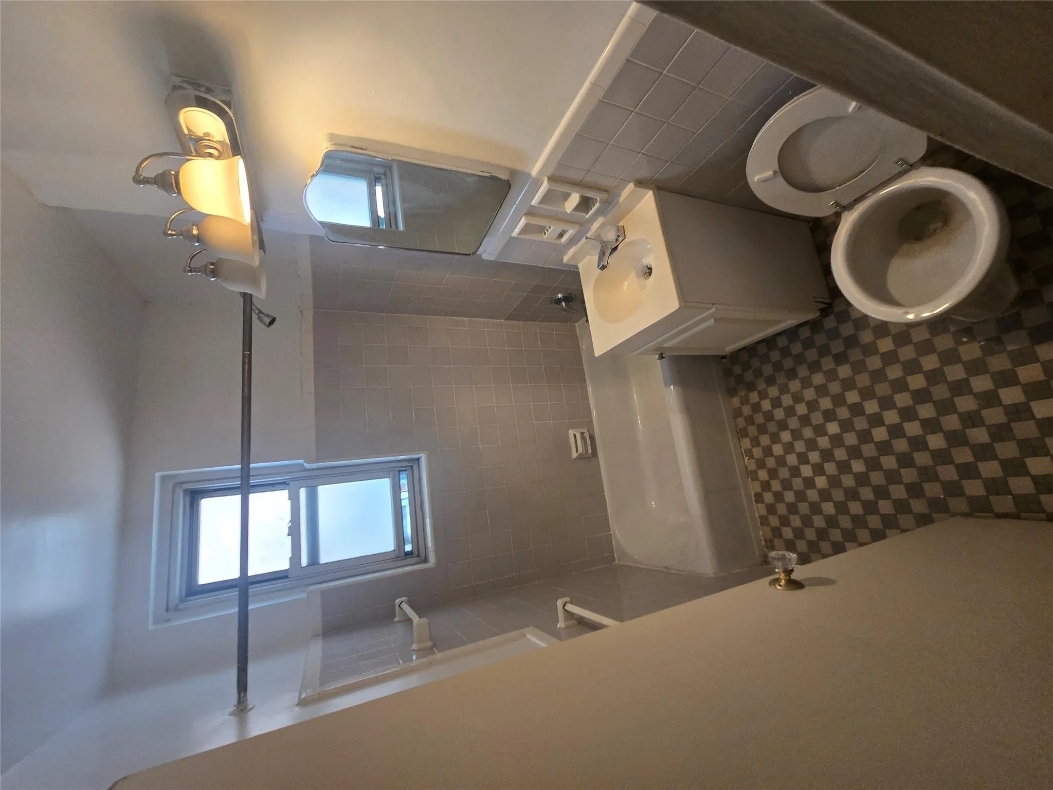 Bathroom with wainscoting, vanity, toilet, tile patterned floors, and shower combination Bathroom with wainscoting, vanity, toilet, tile patterned floors, and shower combination