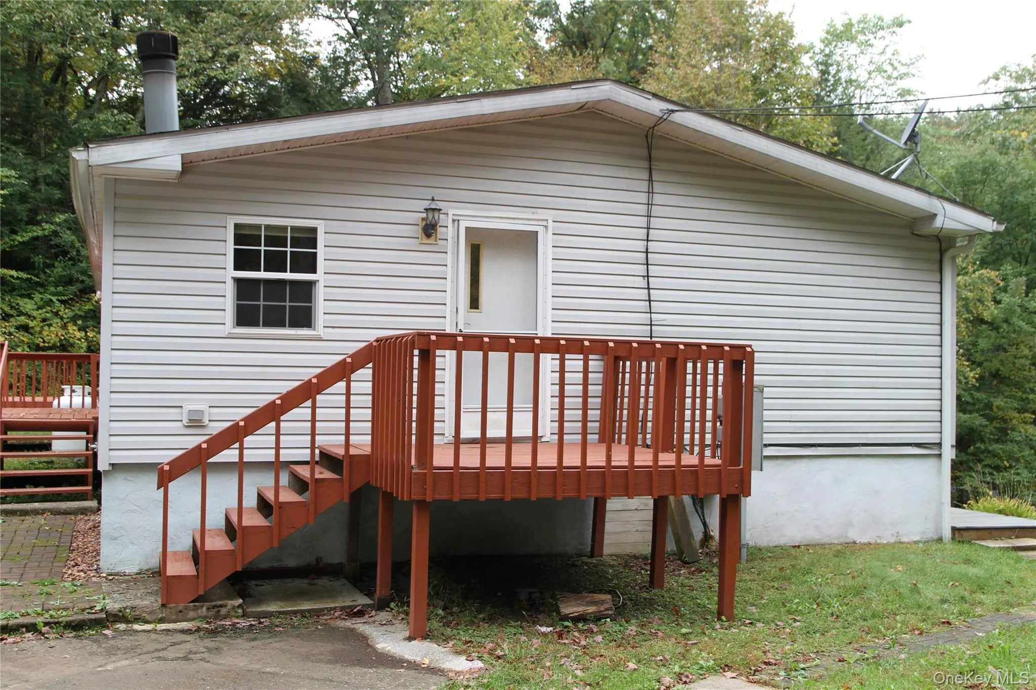 Rear view of property with a wooden deck Rear view of property with a wooden deck