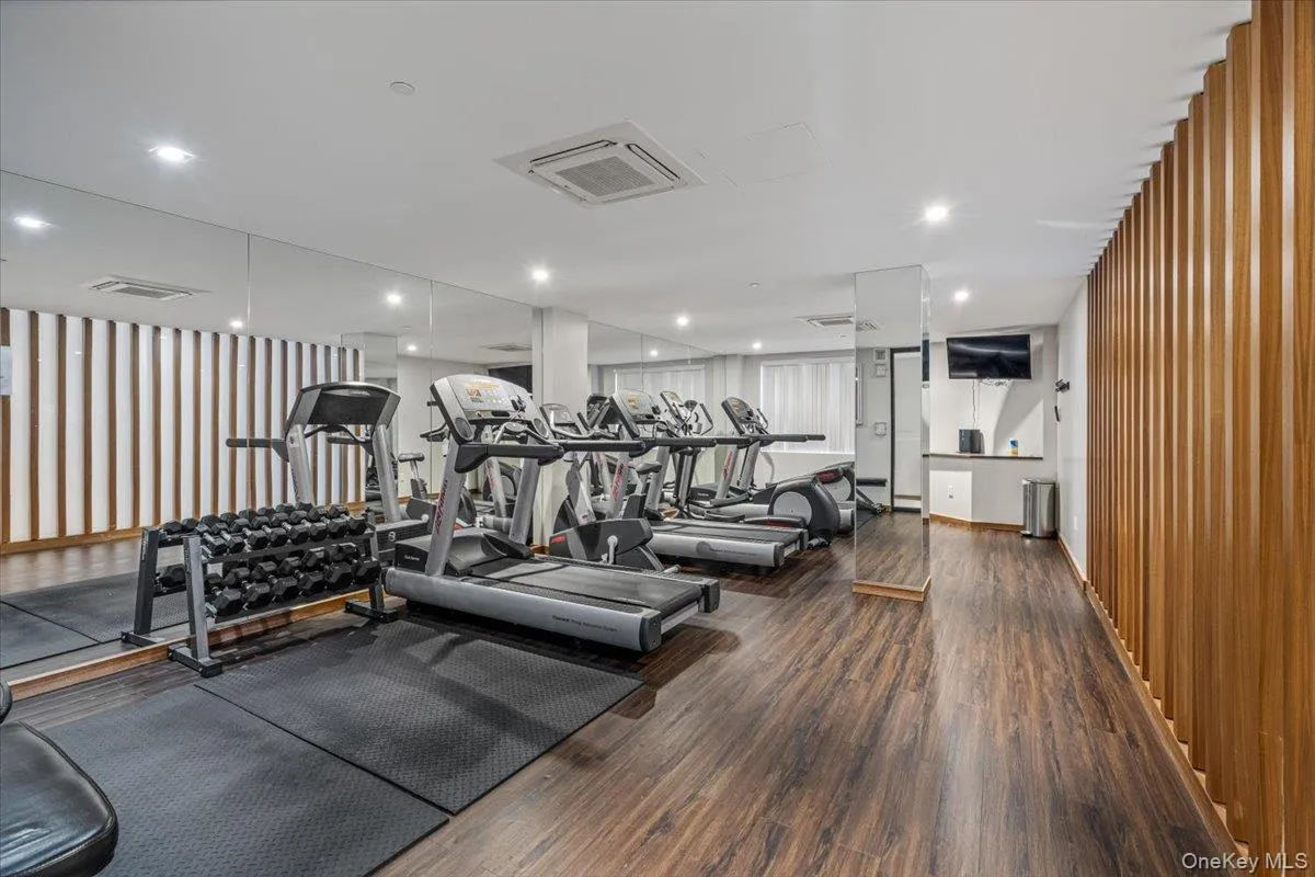Exercise room with visible vents and wood finished floors Exercise room with visible vents and wood finished floors