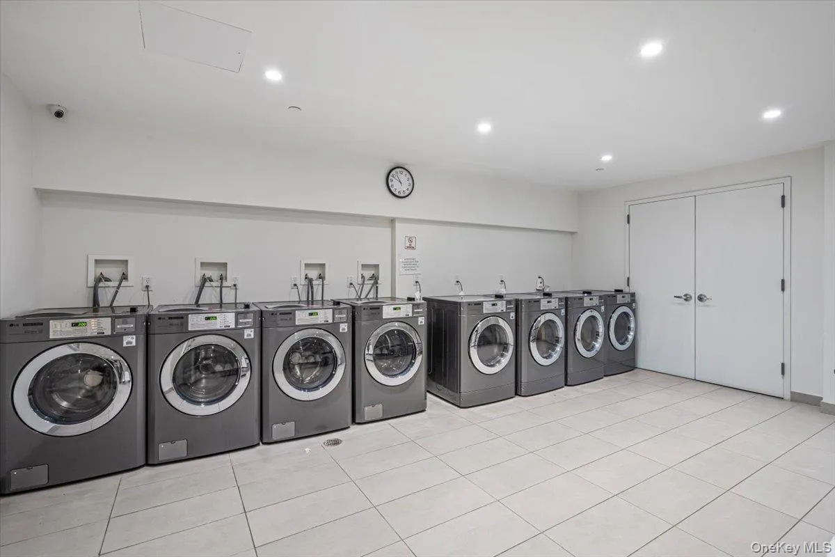 Shared laundry area featuring washer and dryer, recessed lighting, and light tile patterned floors Shared laundry area featuring washer and dryer, recessed lighting, and light tile patterned floors