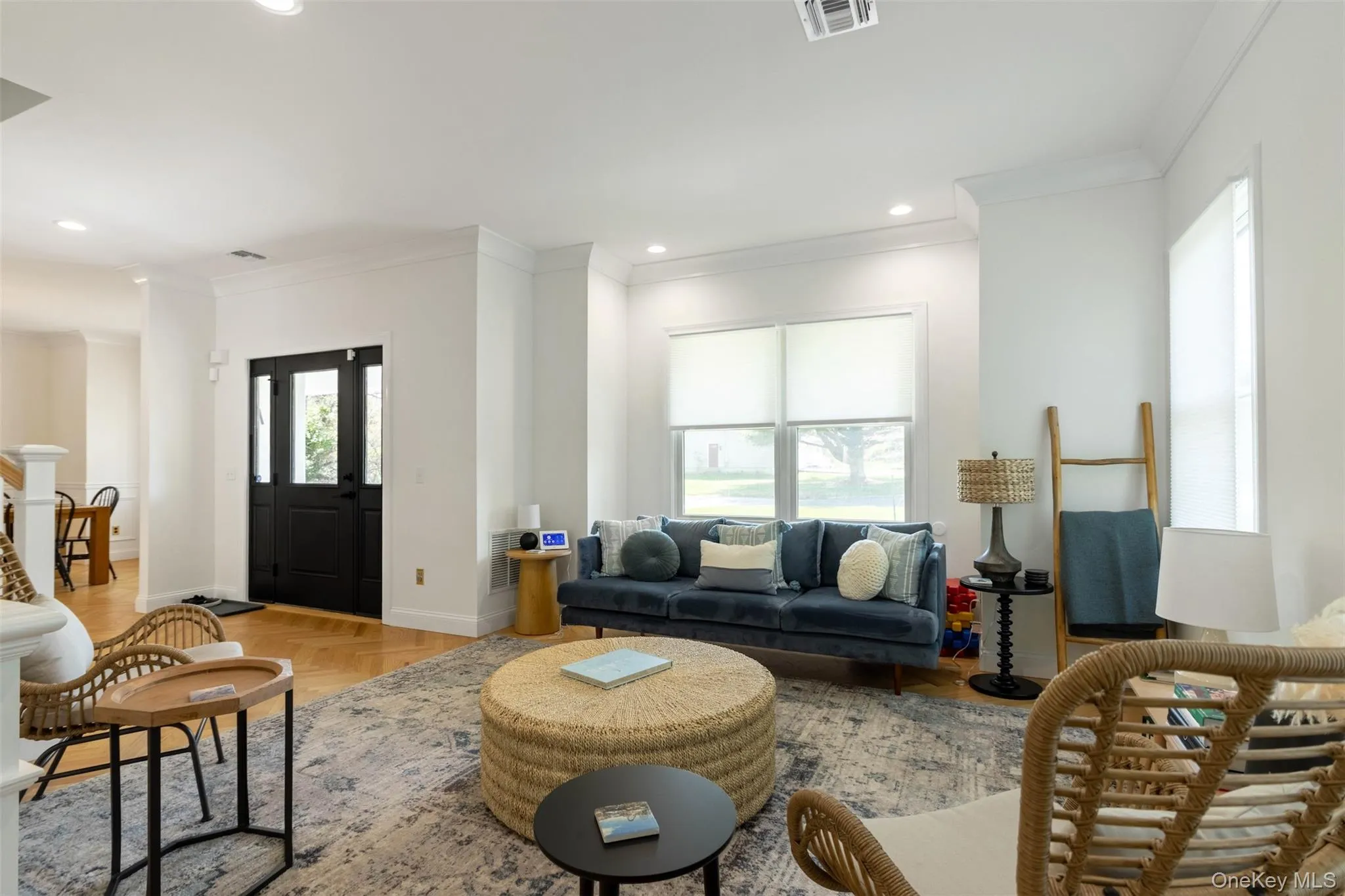 Living area featuring visible vents, ornamental molding, baseboards, and recessed lighting Living area featuring visible vents, ornamental molding, baseboards, and recessed lighting