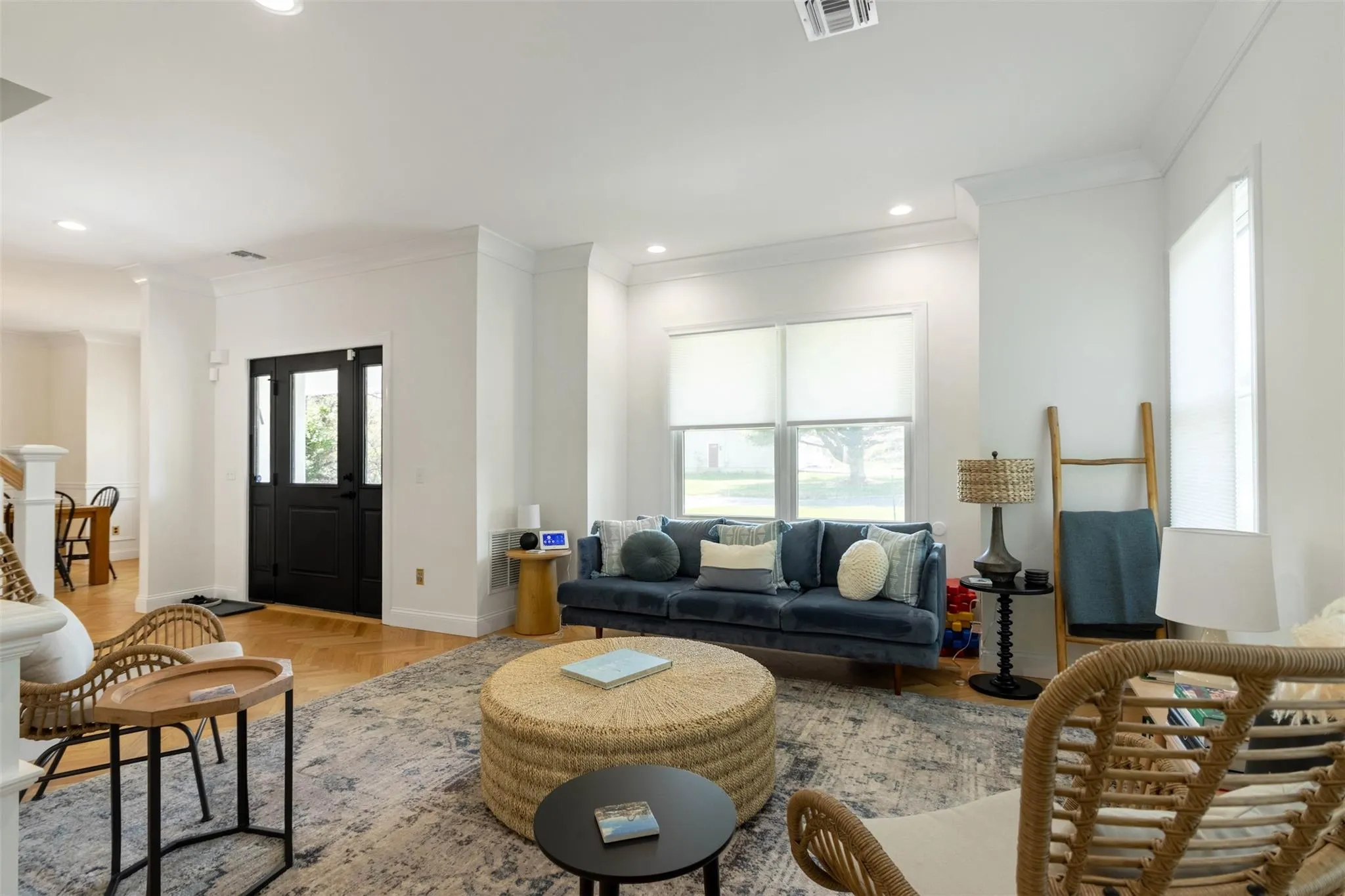 Living area featuring visible vents, ornamental molding, baseboards, and recessed lighting Living area featuring visible vents, ornamental molding, baseboards, and recessed lighting
