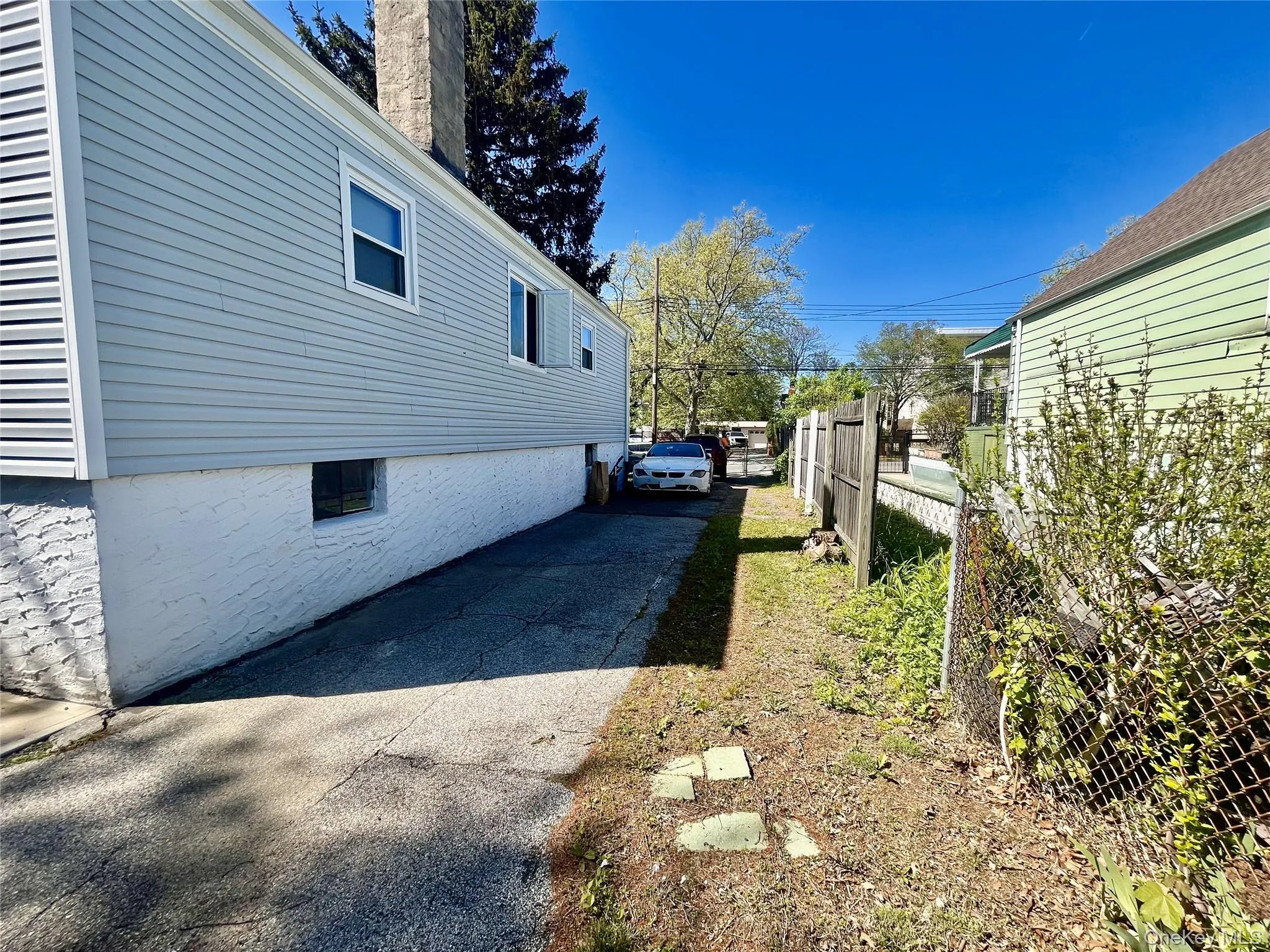 View of side of property with fence and a chimney View of side of property with fence and a chimney