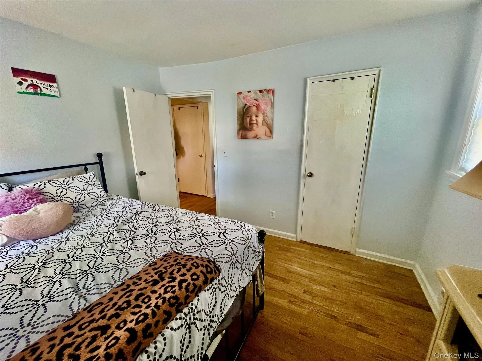 Bedroom with baseboards and wood finished floors Bedroom with baseboards and wood finished floors