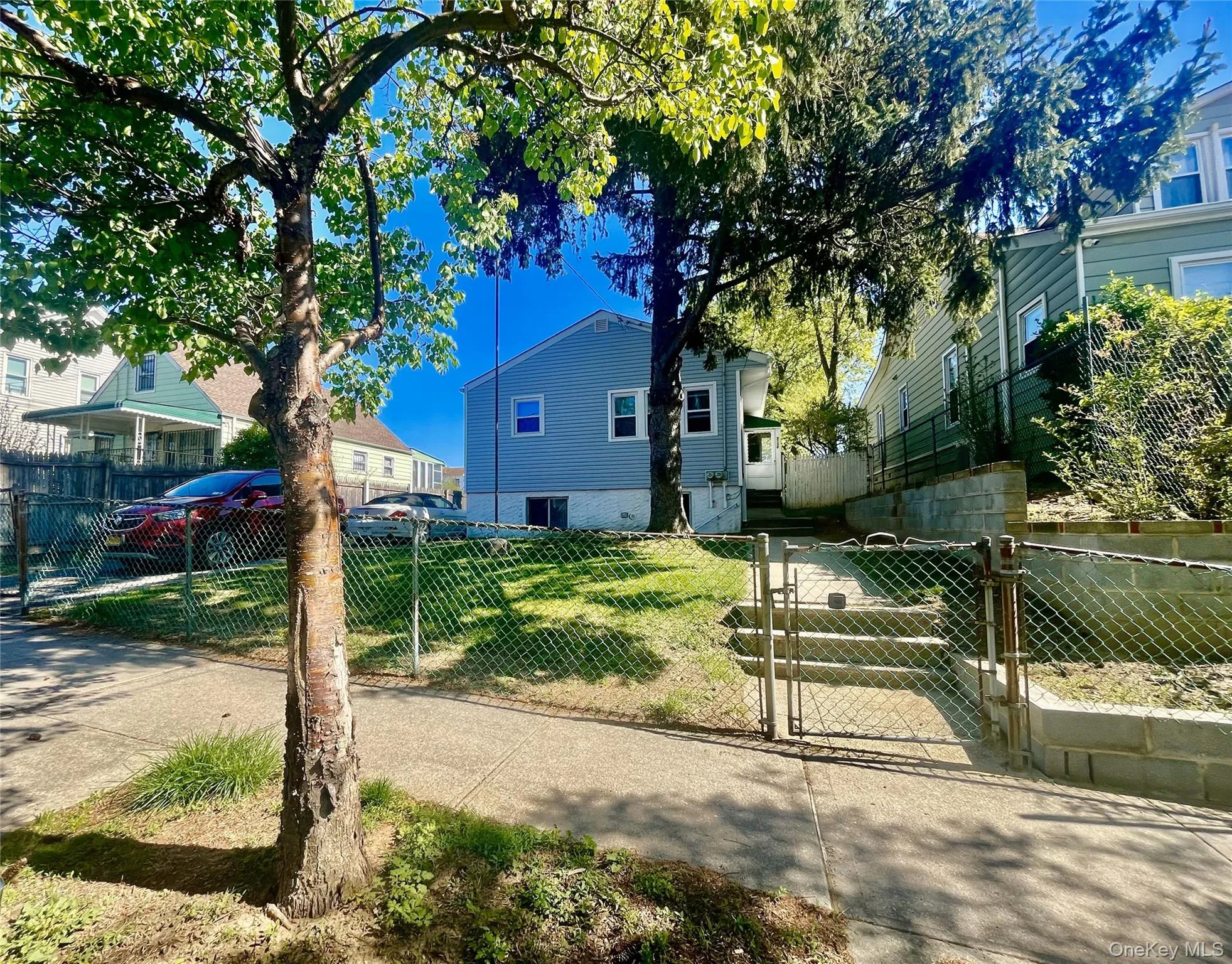 Bungalow with a fenced front yard, a gate, and a front lawn Bungalow with a fenced front yard, a gate, and a front lawn