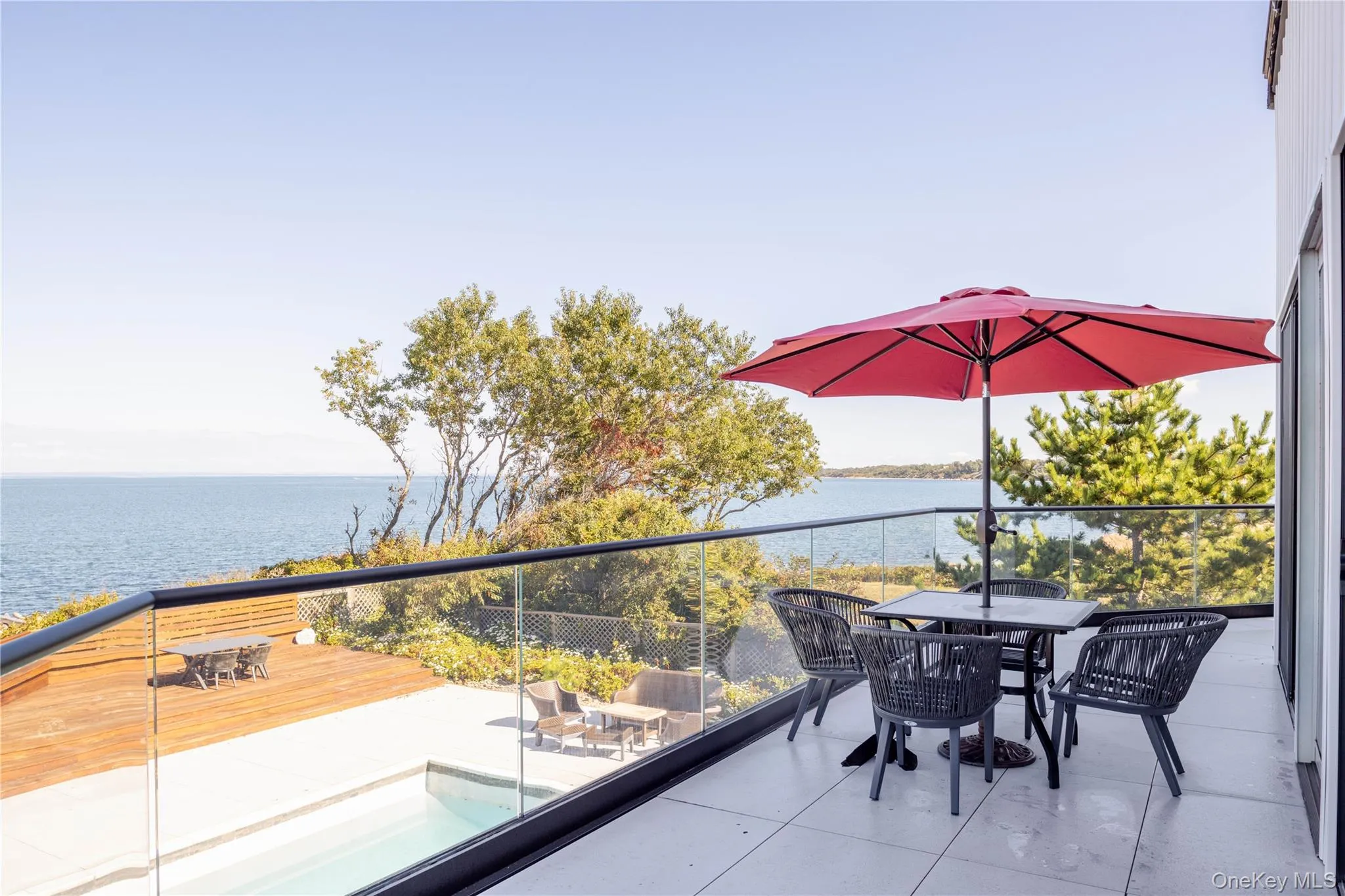 Balcony featuring outdoor dining space and a water view Balcony featuring outdoor dining space and a water view