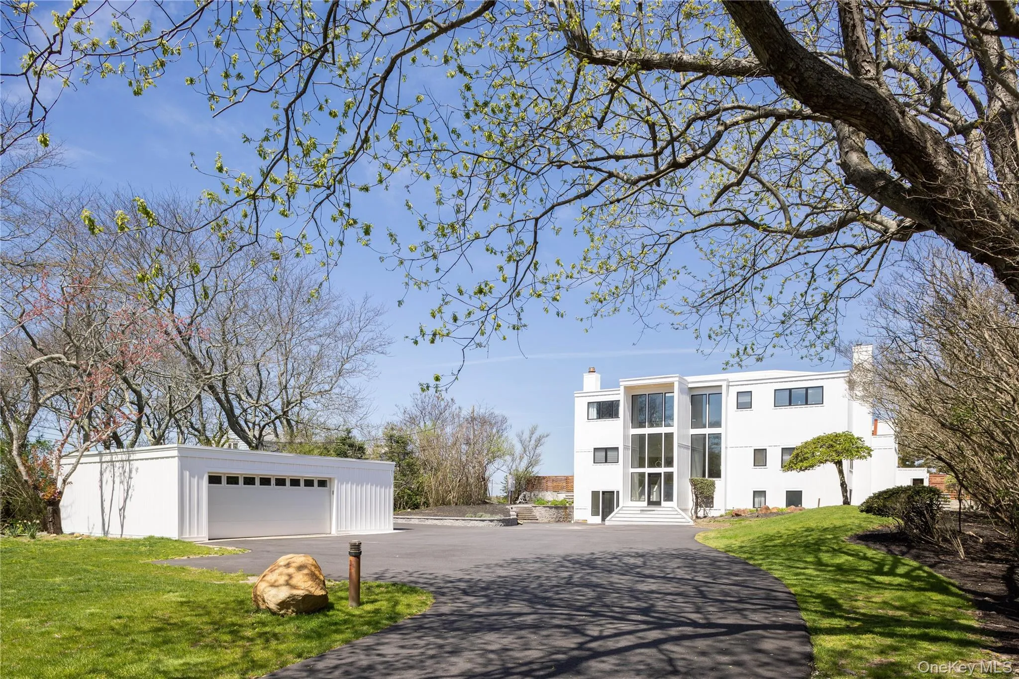 View of front of property with a detached garage, an outbuilding, entry steps, and a front yard View of front of property with a detached garage, an outbuilding, entry steps, and a front yard