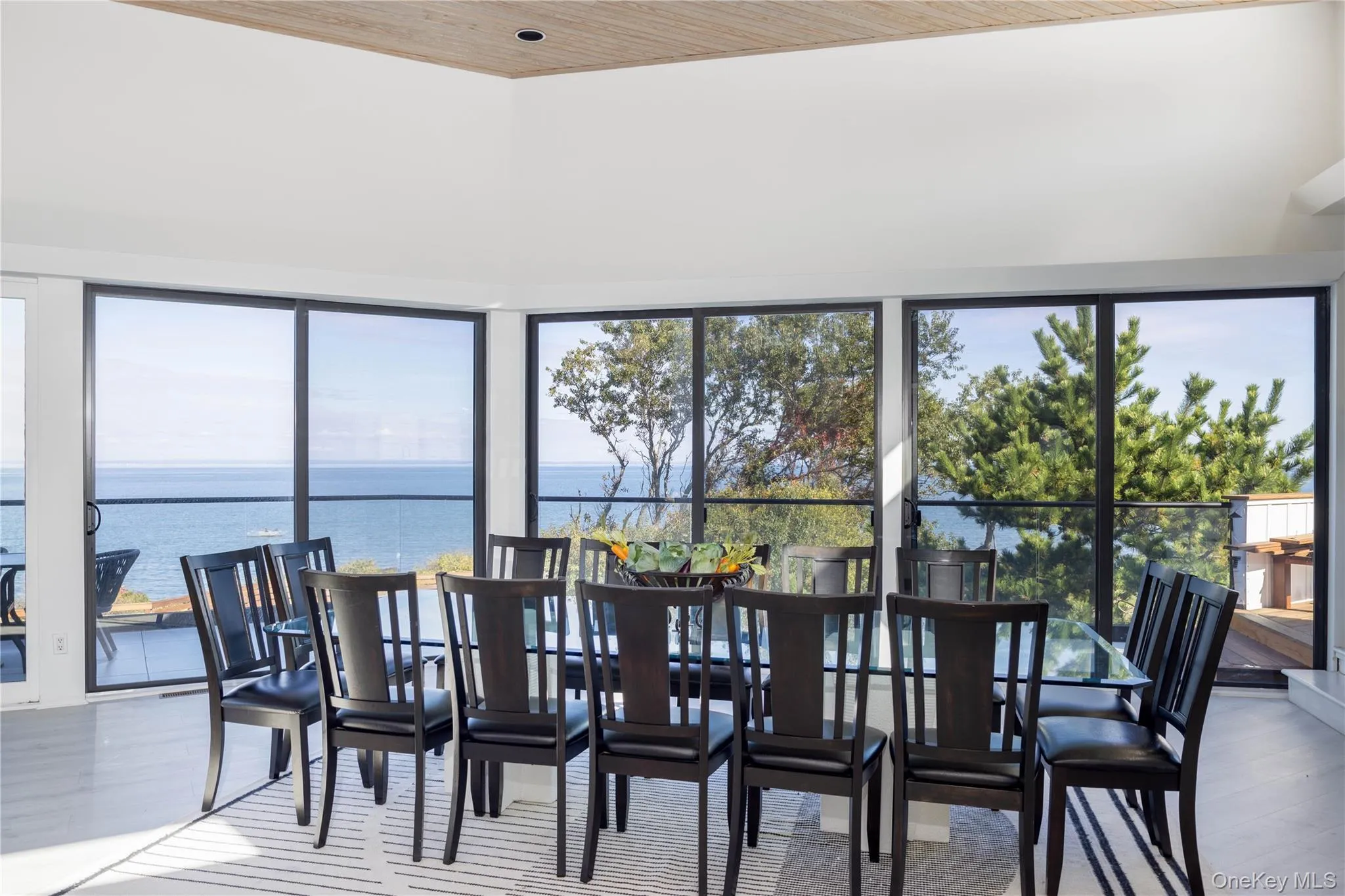 Dining space with a water view, plenty of natural light, and wood finished floors Dining space with a water view, plenty of natural light, and wood finished floors