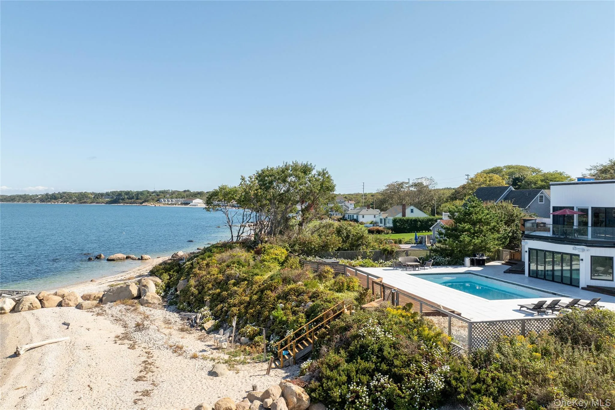 View of swimming pool featuring a fenced in pool and a water view View of swimming pool featuring a fenced in pool and a water view