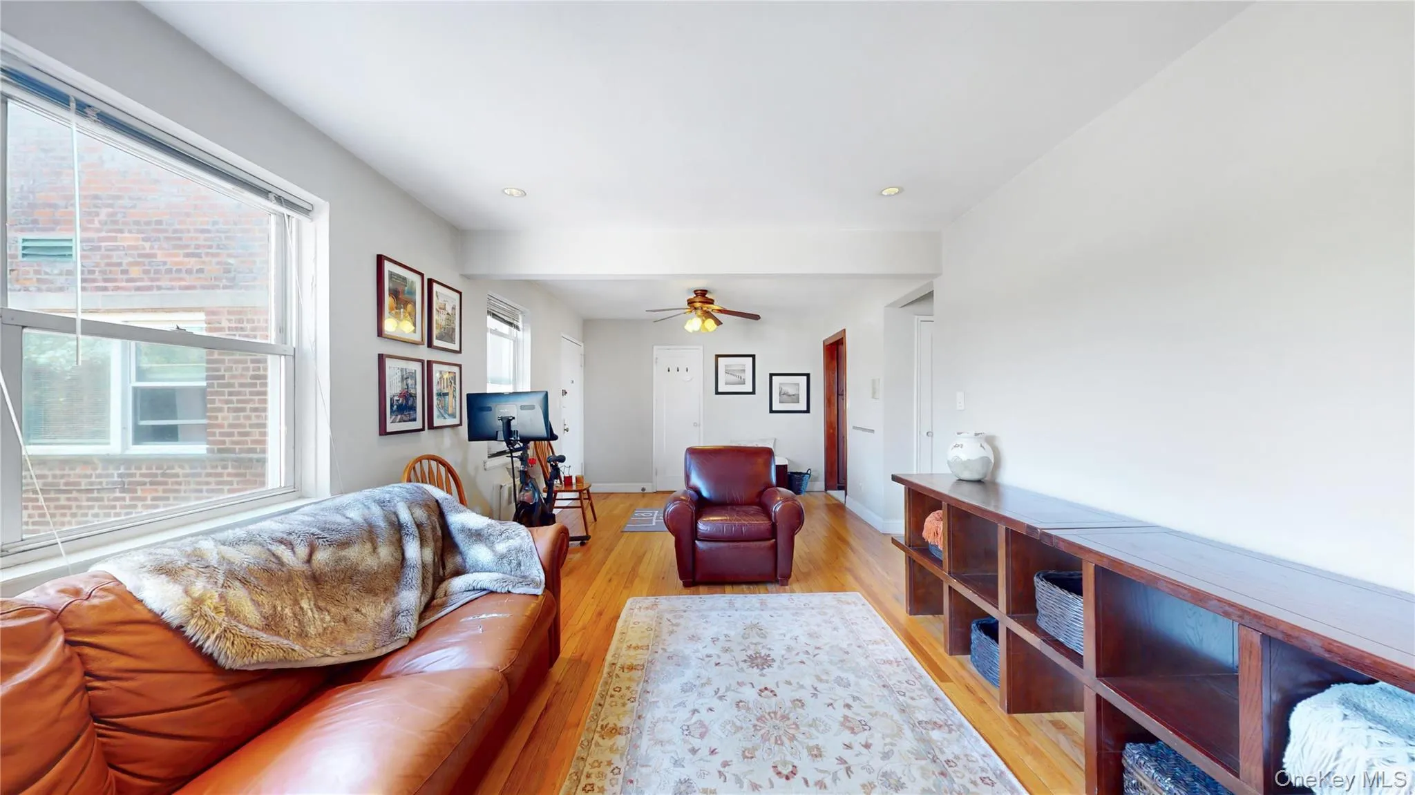 Living area featuring ceiling fan, recessed lighting, baseboards, and light wood-style floors Living area featuring ceiling fan, recessed lighting, baseboards, and light wood-style floors