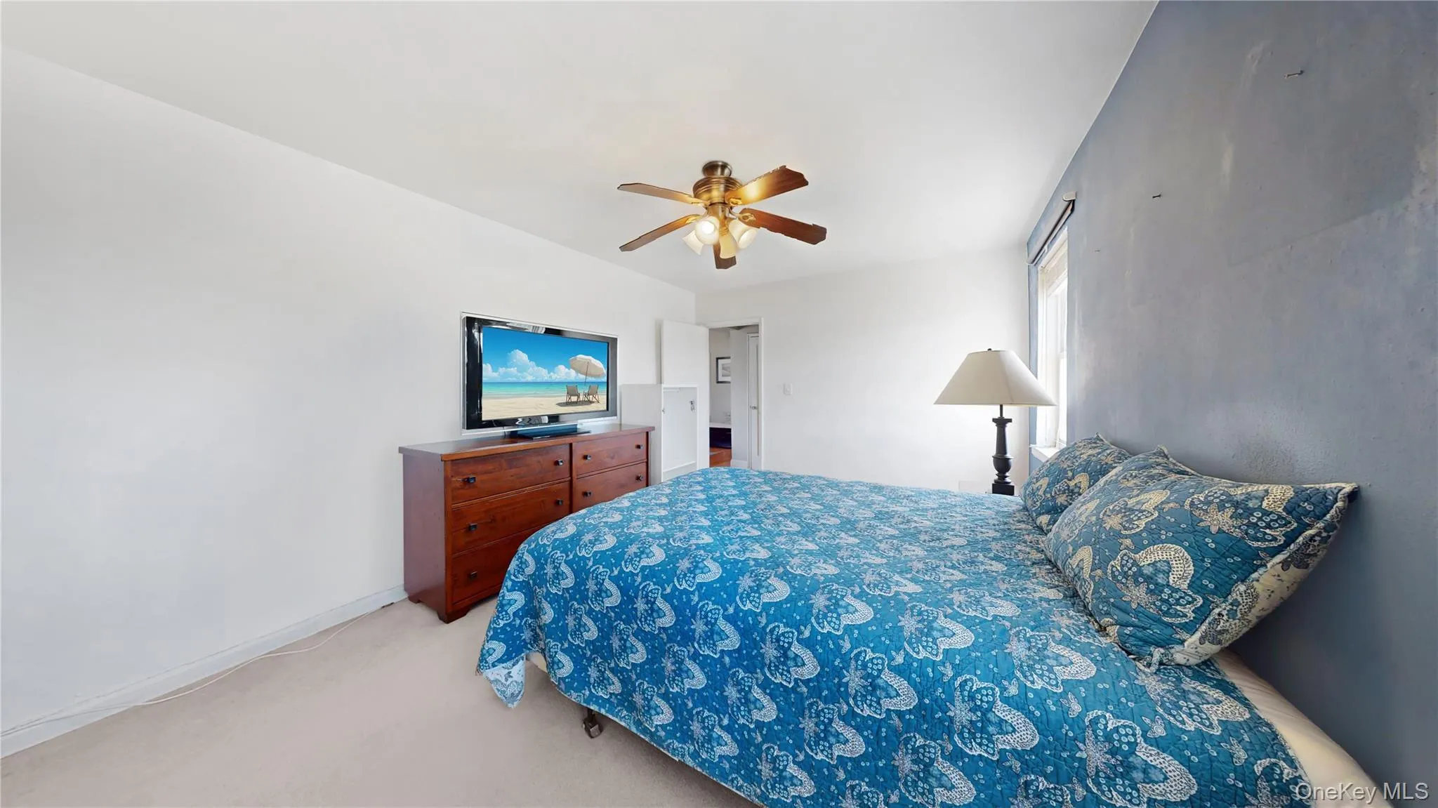 Bedroom with a ceiling fan, baseboards, and light colored carpet Bedroom with a ceiling fan, baseboards, and light colored carpet