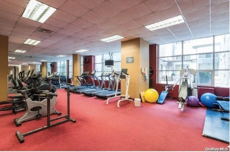 Gym featuring carpet, a drop ceiling, and visible vents Gym featuring carpet, a drop ceiling, and visible vents