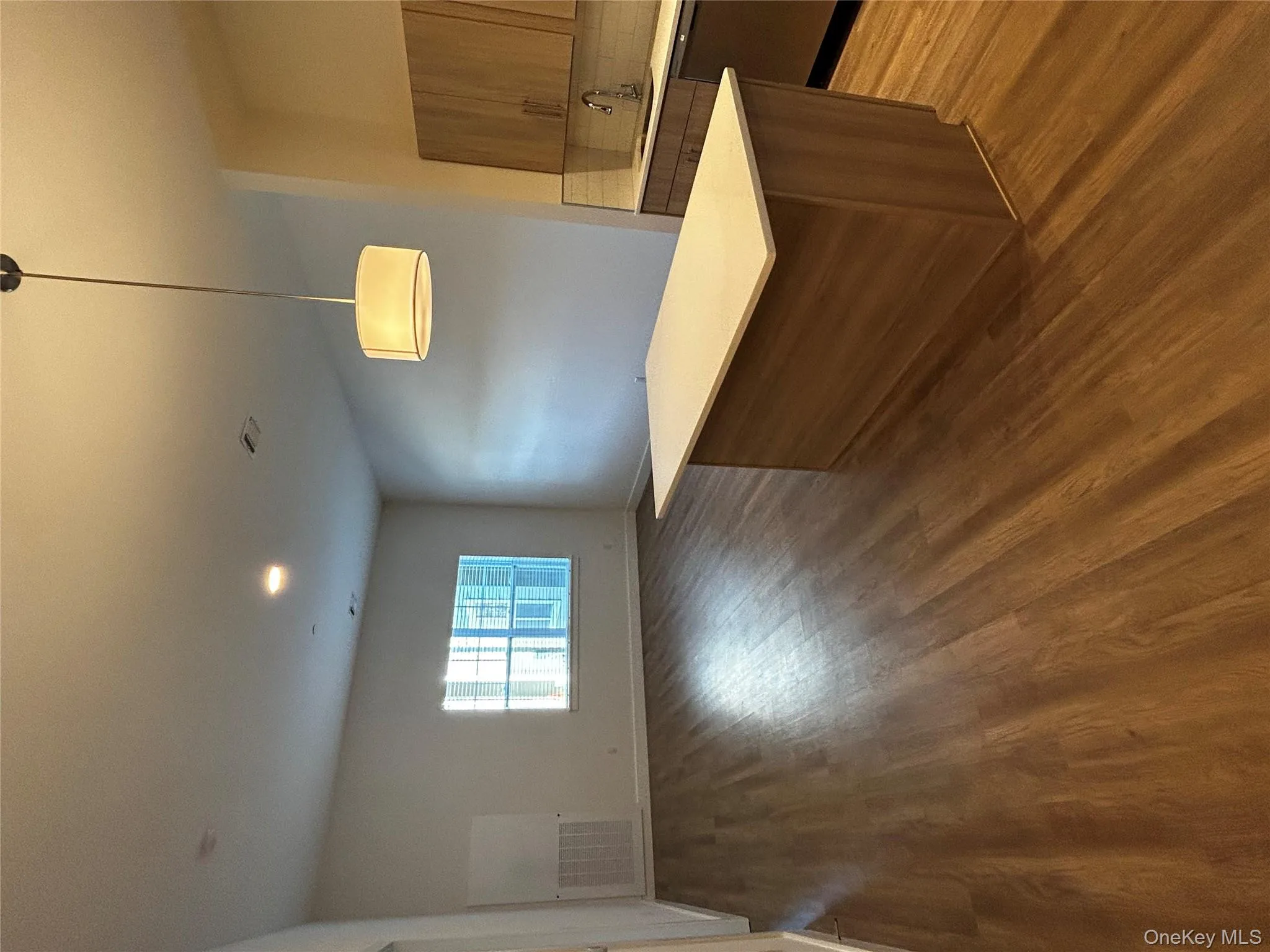 Kitchen with a sink, light countertops, dark wood-type flooring, and dishwasher Kitchen with a sink, light countertops, dark wood-type flooring, and dishwasher