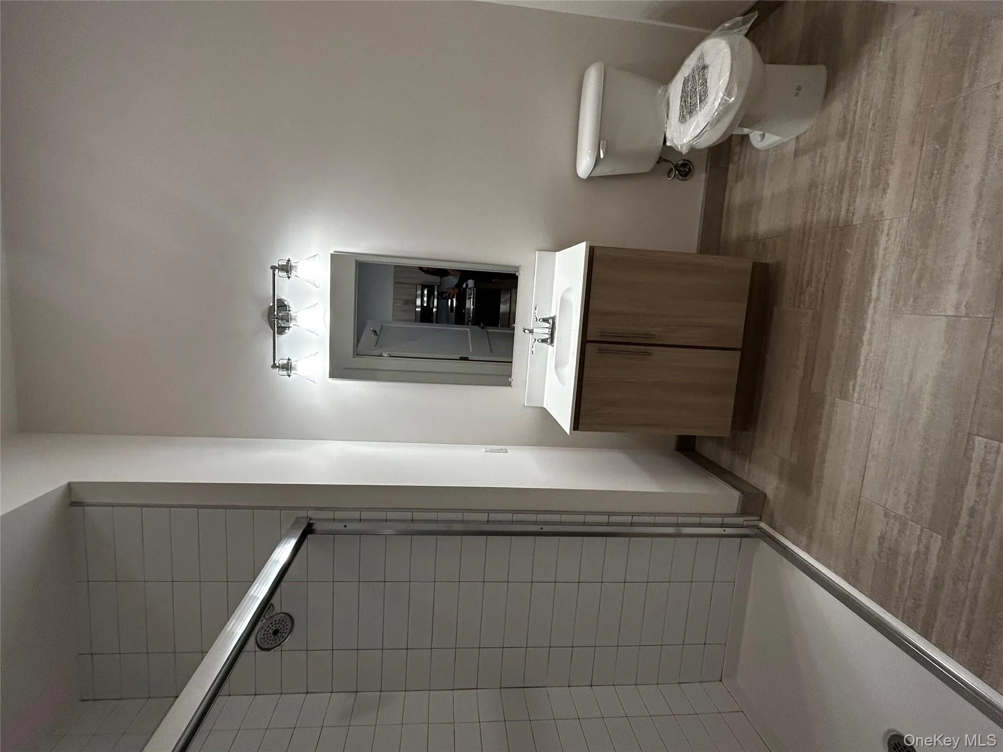 Full bath featuring toilet, baseboards, a shower stall, and vanity Full bath featuring toilet, baseboards, a shower stall, and vanity