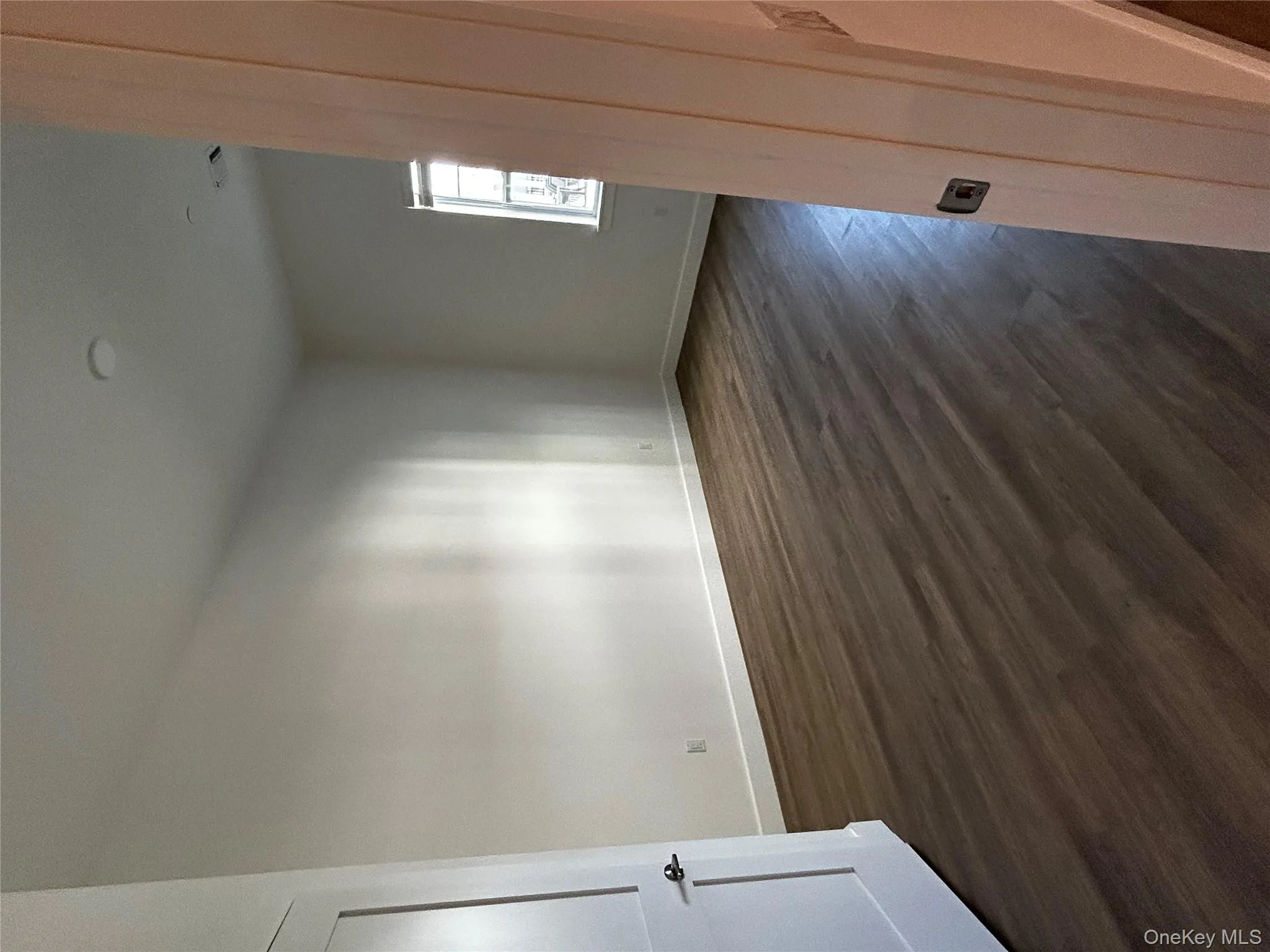 Spare room with baseboards, visible vents, and dark wood-type flooring Spare room with baseboards, visible vents, and dark wood-type flooring