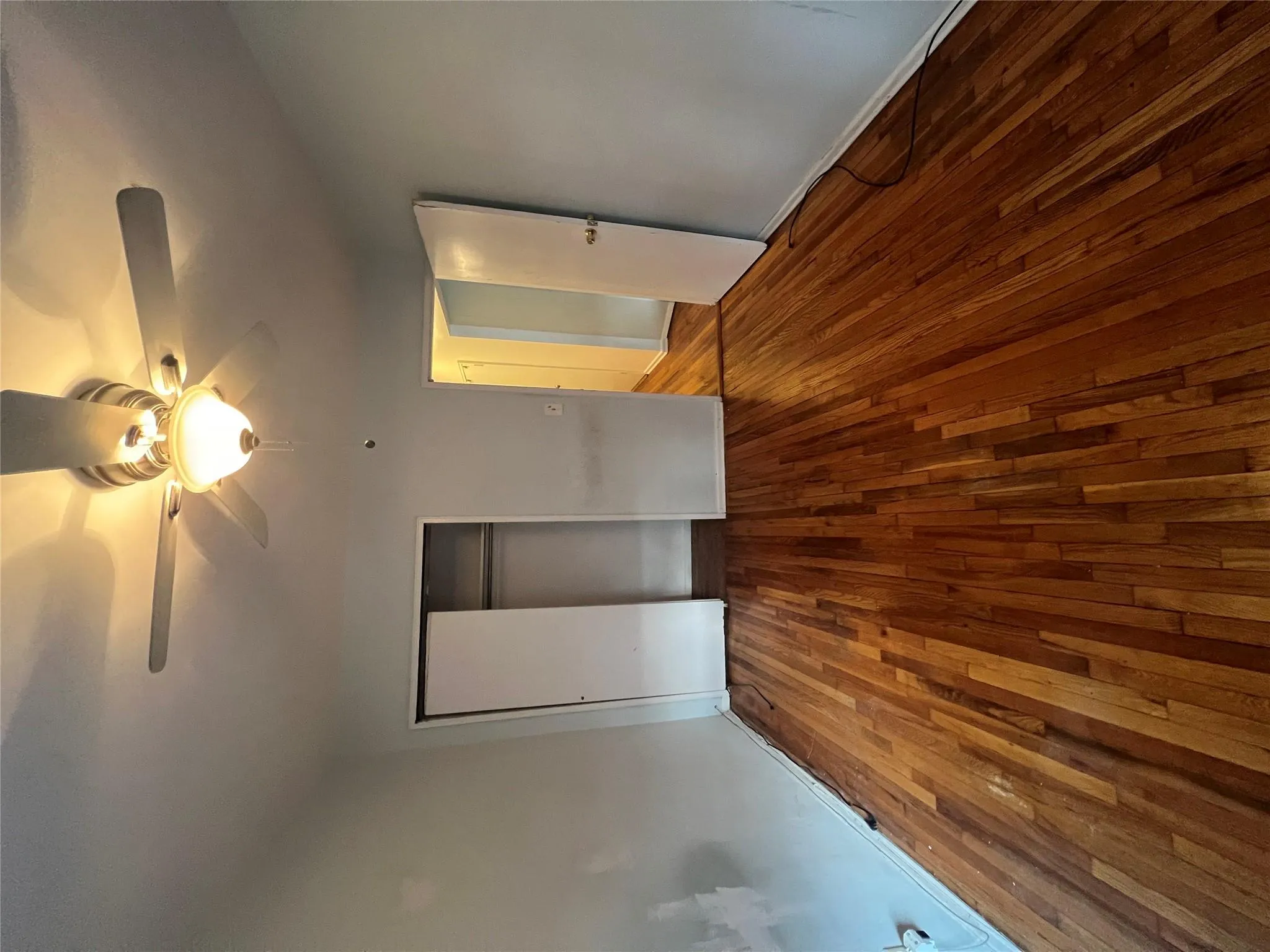Unfurnished bedroom with wood-type flooring, a ceiling fan, baseboards, and a closet Unfurnished bedroom with wood-type flooring, a ceiling fan, baseboards, and a closet