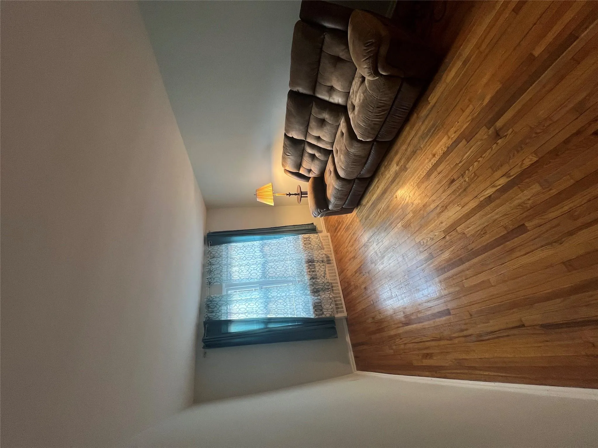 Living room with baseboards and hardwood / wood-style floors Living room with baseboards and hardwood / wood-style floors