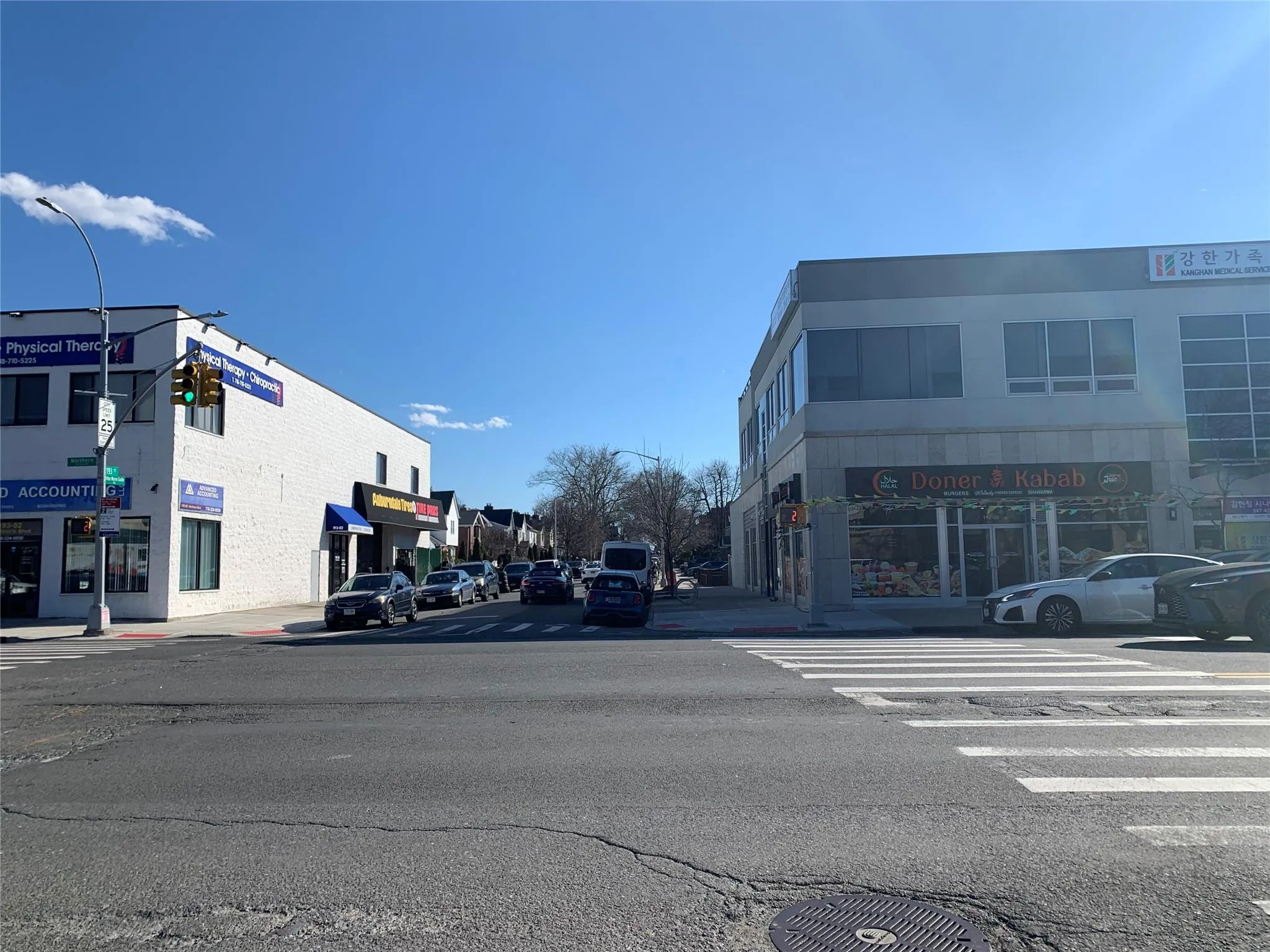 View of street with street lights, sidewalks, and curbs View of street with street lights, sidewalks, and curbs
