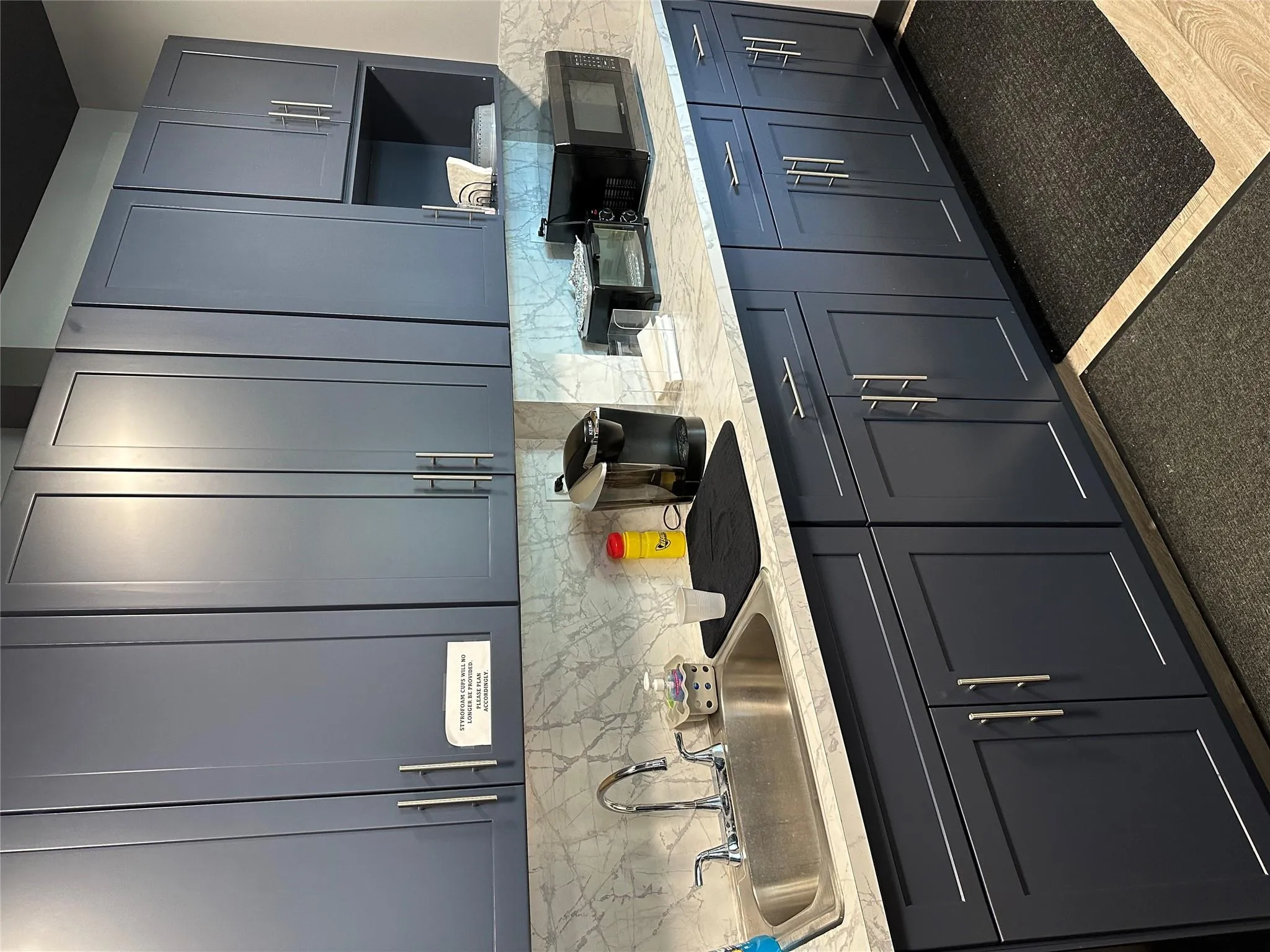 Kitchen featuring backsplash, a toaster, and a sink Kitchen featuring backsplash, a toaster, and a sink