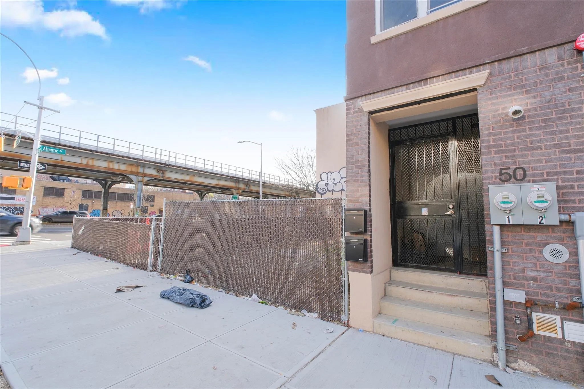 Entrance to property with brick siding and fence Entrance to property with brick siding and fence