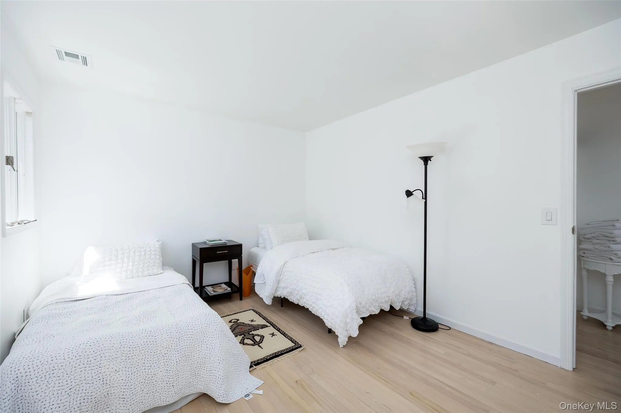 Bedroom featuring light wood-style floors and baseboards Bedroom featuring light wood-style floors and baseboards
