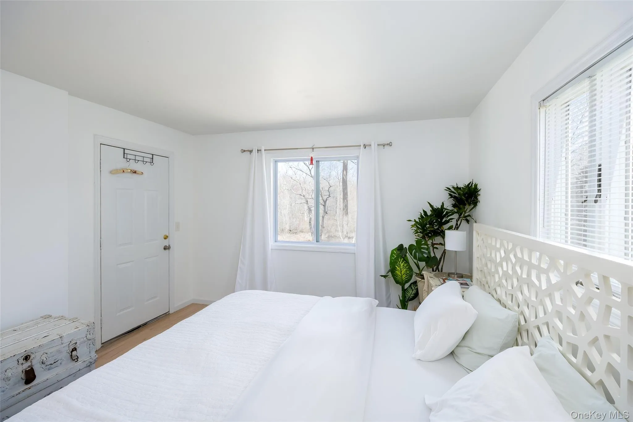 Bedroom featuring wood finished floors and baseboards Bedroom featuring wood finished floors and baseboards
