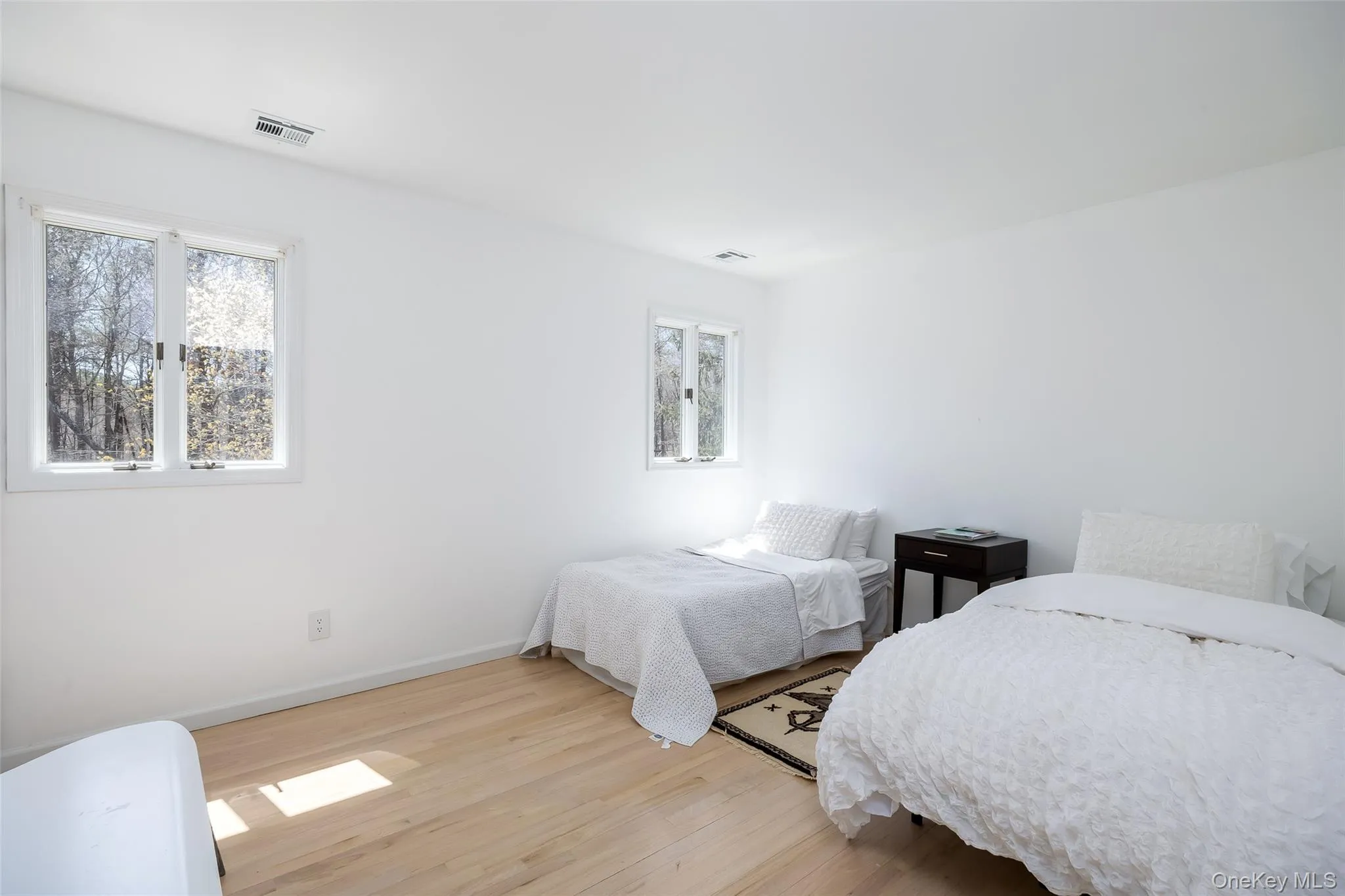 Bedroom featuring light wood-type flooring and baseboards Bedroom featuring light wood-type flooring and baseboards