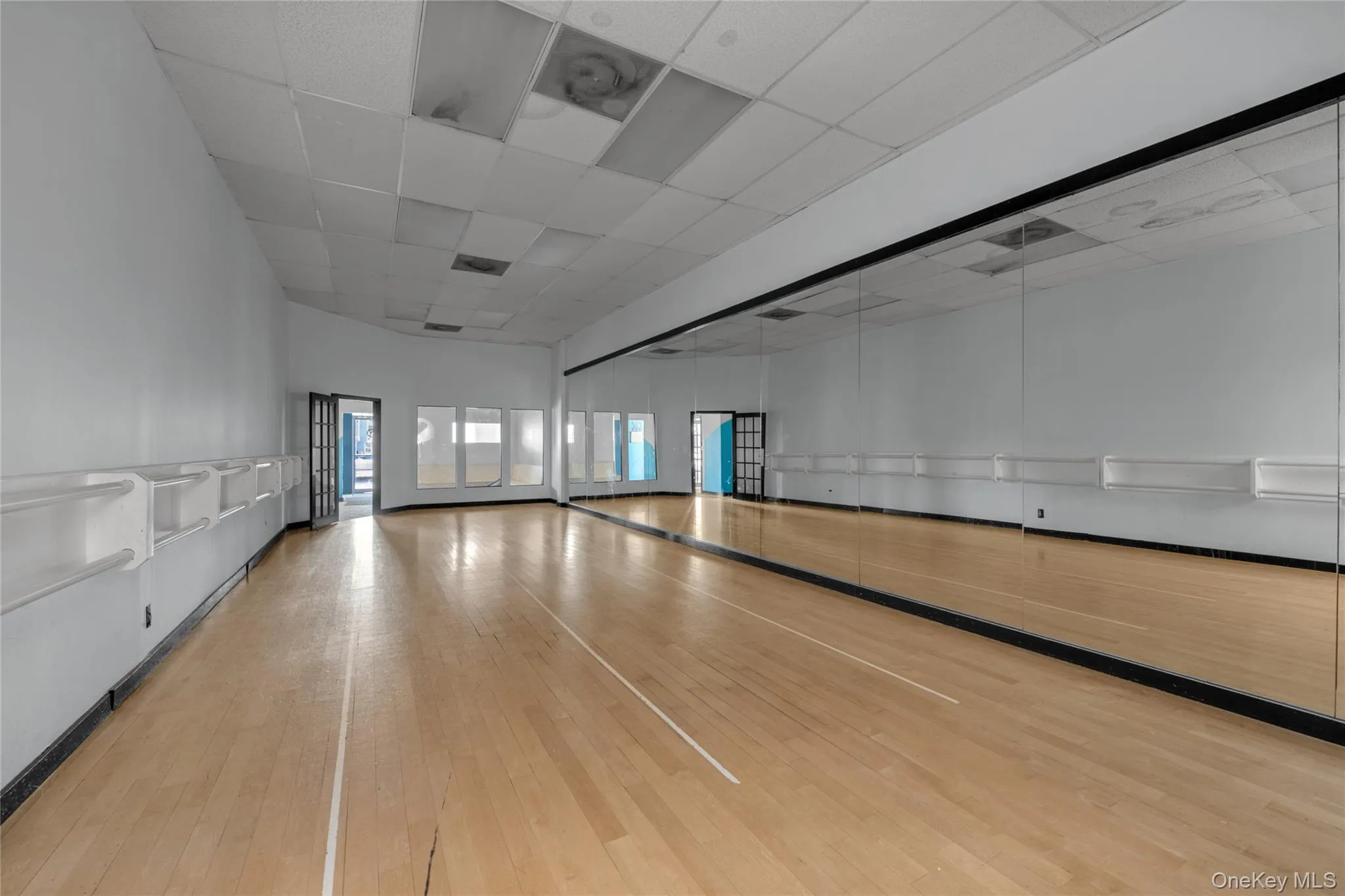 Empty room featuring a drop ceiling and light wood-type flooring Empty room featuring a drop ceiling and light wood-type flooring
