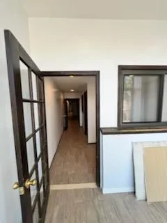 Corridor featuring wood finished floors Corridor featuring wood finished floors
