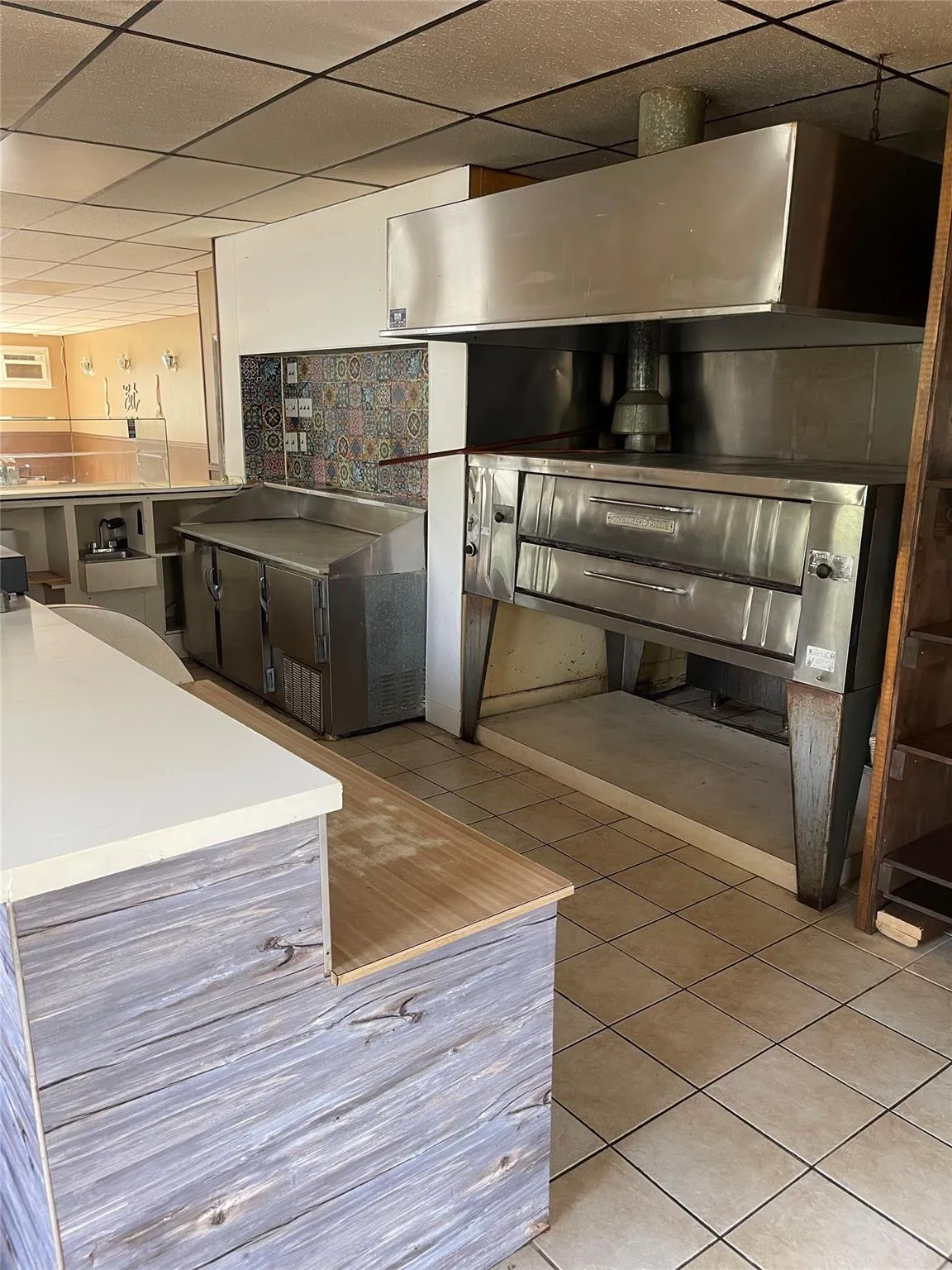 Kitchen with tile patterned floors and a drop ceiling Kitchen with tile patterned floors and a drop ceiling