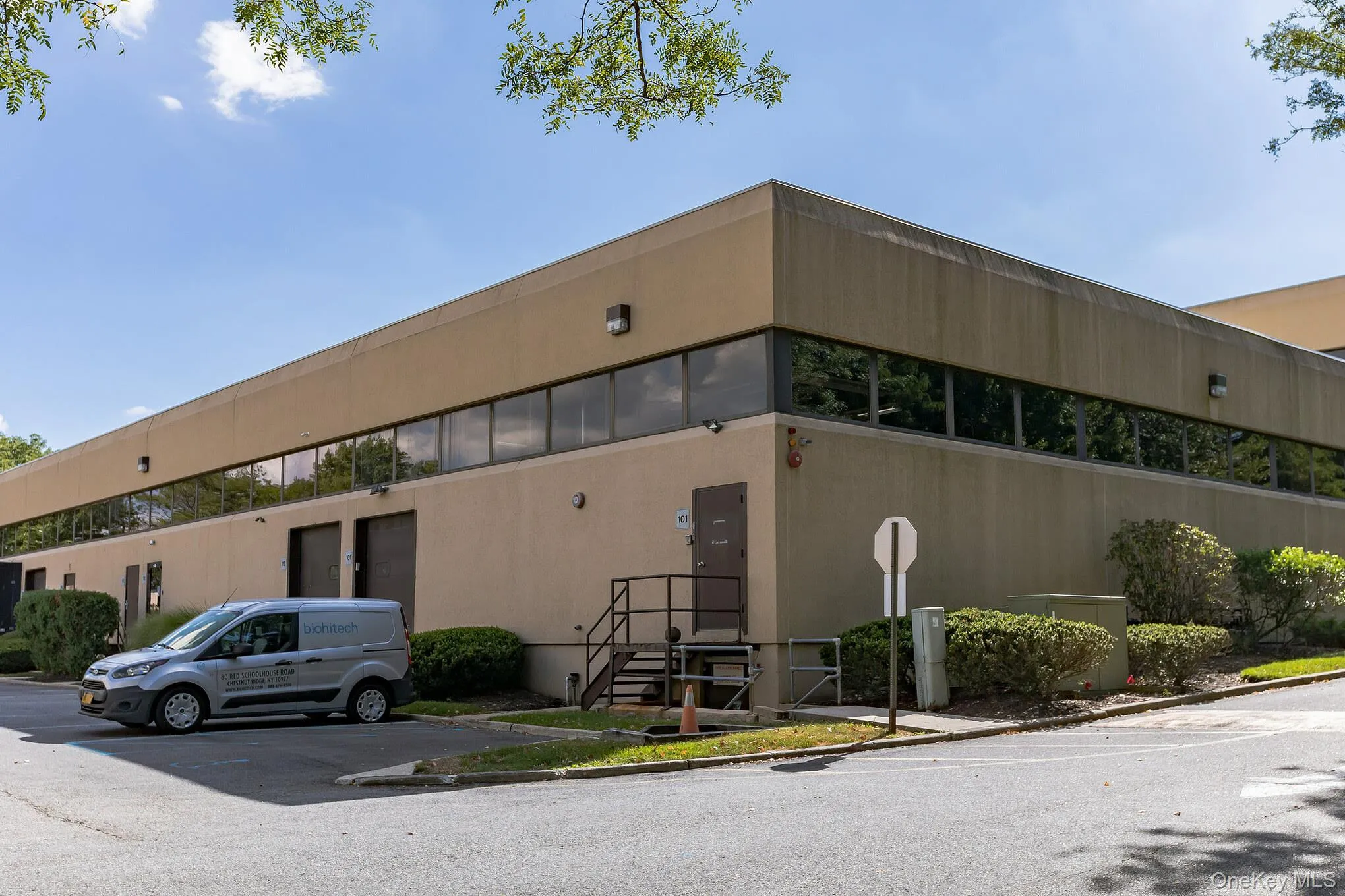 View of building exterior featuring uncovered parking View of building exterior featuring uncovered parking