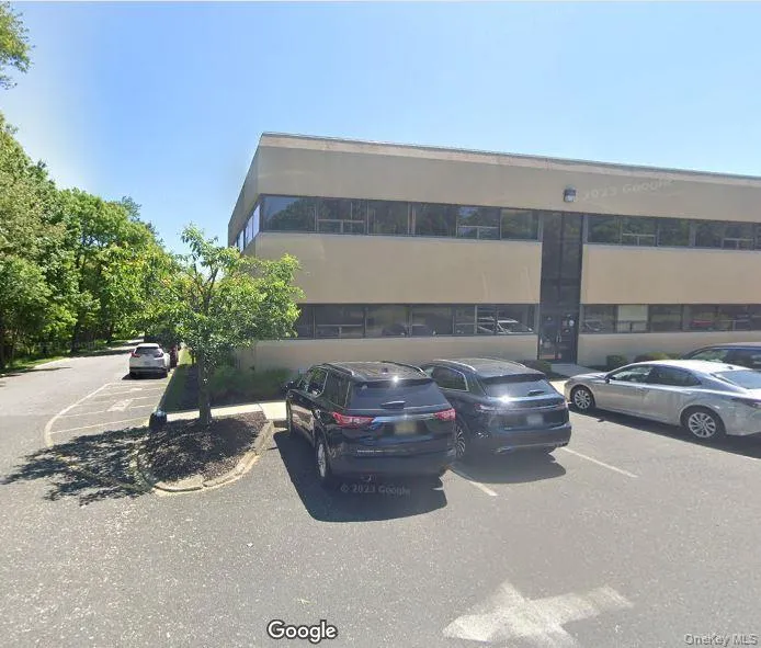 View of apartment building / complex with uncovered parking View of apartment building / complex with uncovered parking