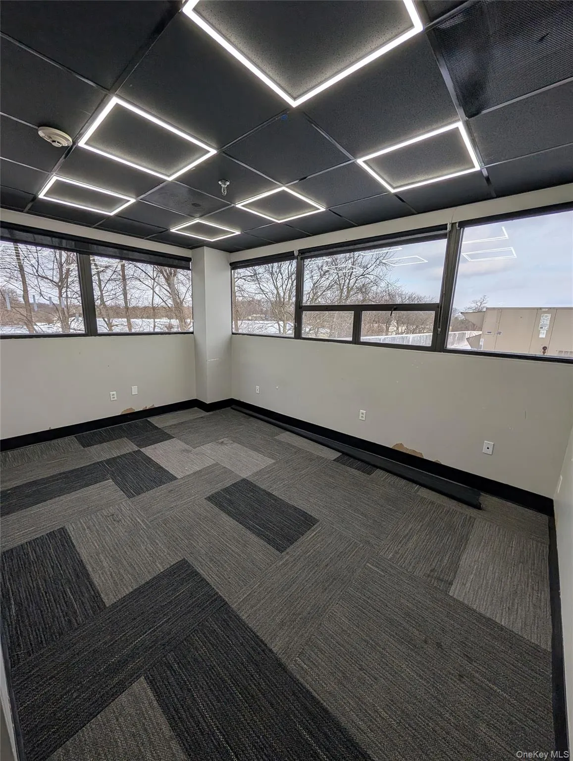 Spare room with baseboards and carpet Spare room with baseboards and carpet