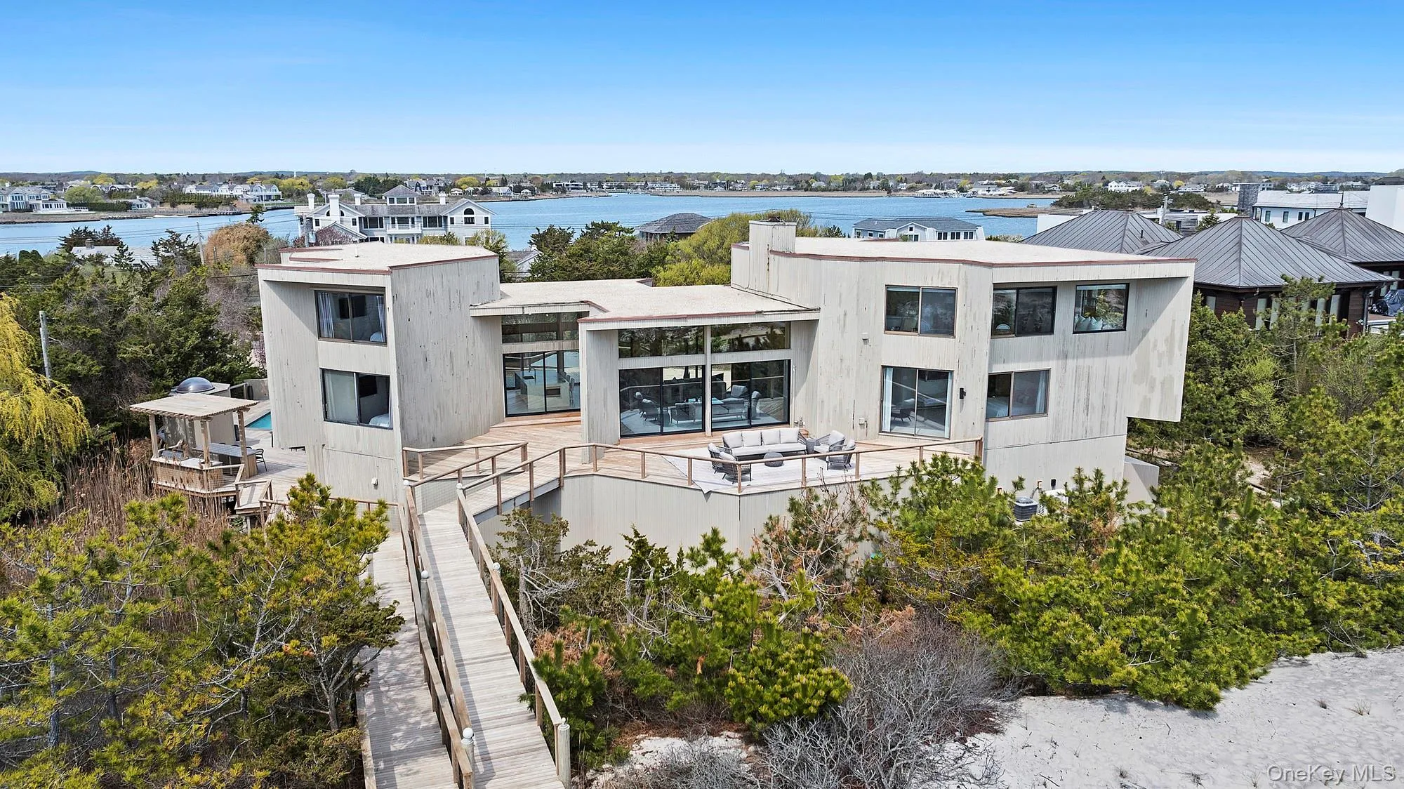 Rear view of property with a balcony and a water view
