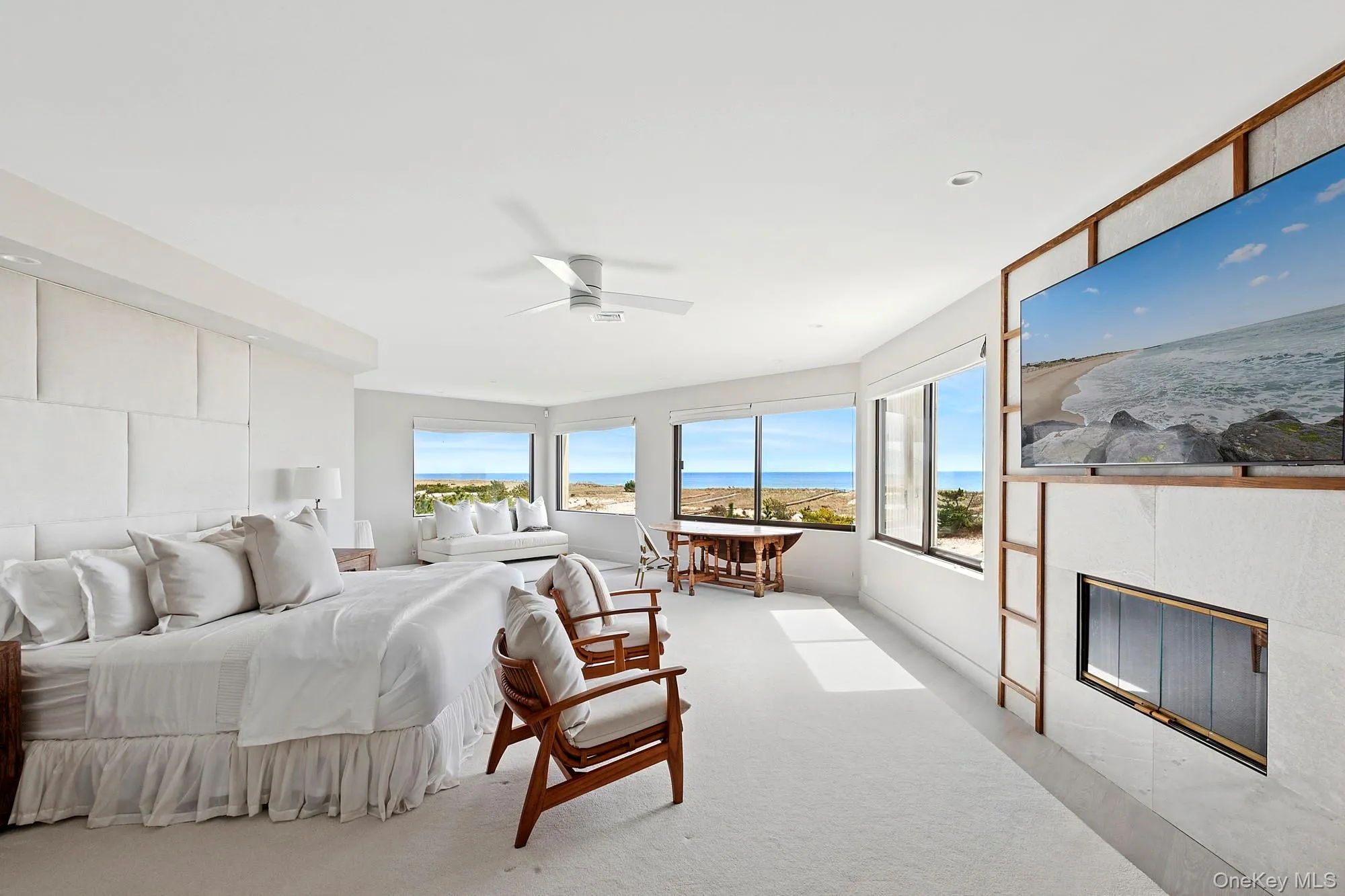 Bedroom with carpet flooring, a tile fireplace, ceiling fan, and access to exterior
