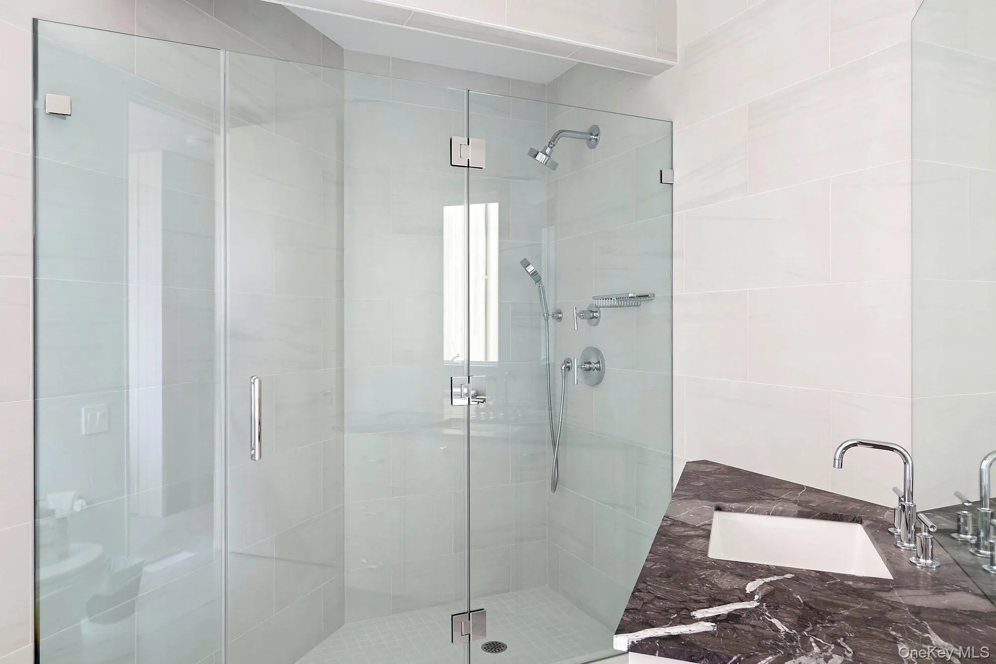 Bathroom with a stall shower and a sink