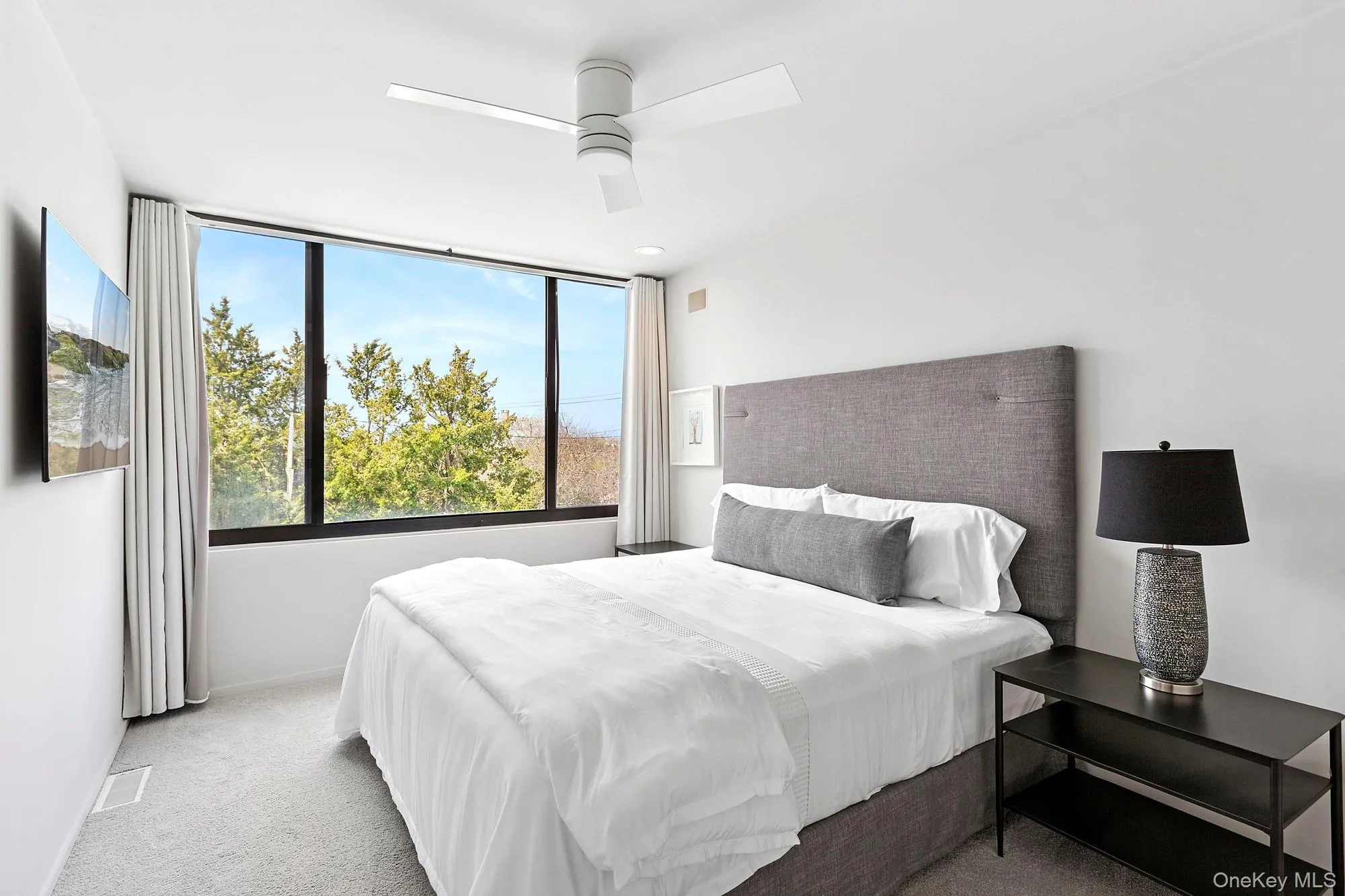 Carpeted bedroom featuring baseboards, a ceiling fan, and visible vents