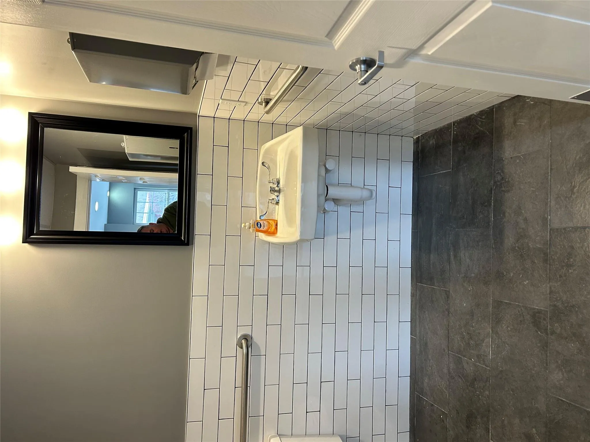Bathroom featuring tile walls and wainscoting Bathroom featuring tile walls and wainscoting