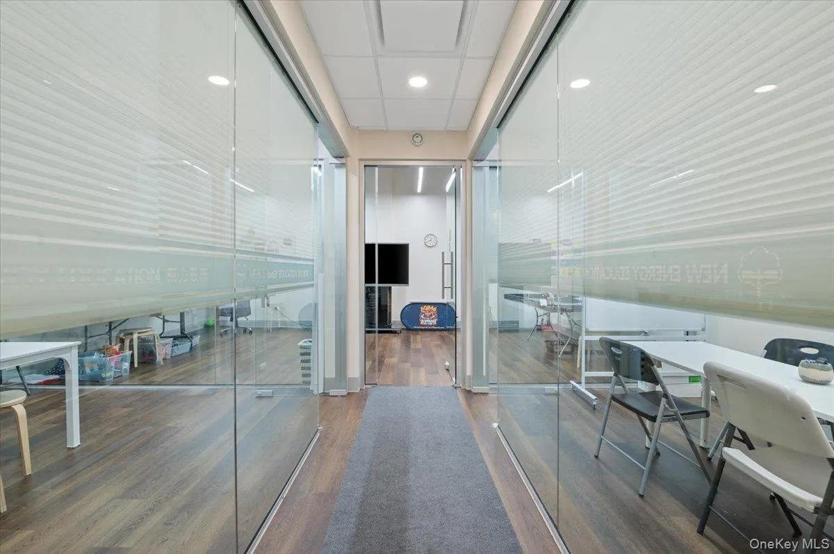 Hallway featuring wood finished floors Hallway featuring wood finished floors