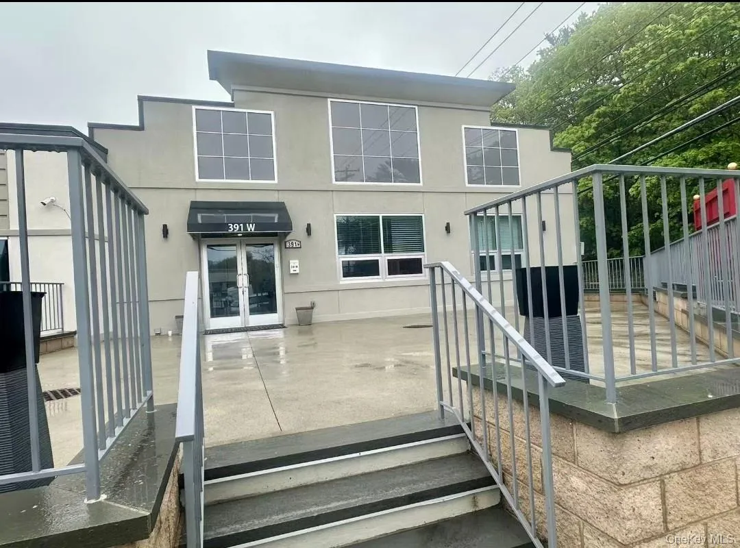 Back of property featuring stucco siding Back of property featuring stucco siding
