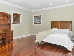 Bedroom featuring wood finished floors, ornamental molding, baseboards, and recessed lighting Bedroom featuring wood finished floors, ornamental molding, baseboards, and recessed lighting