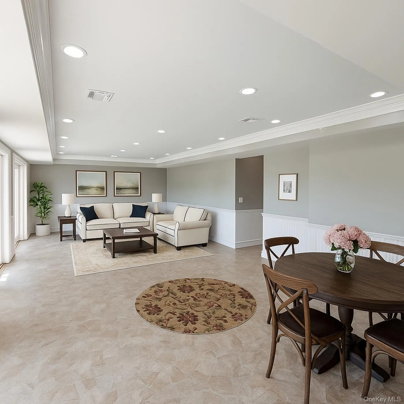 Living room with recessed lighting, a wainscoted wall, and ornamental molding Living room with recessed lighting, a wainscoted wall, and ornamental molding
