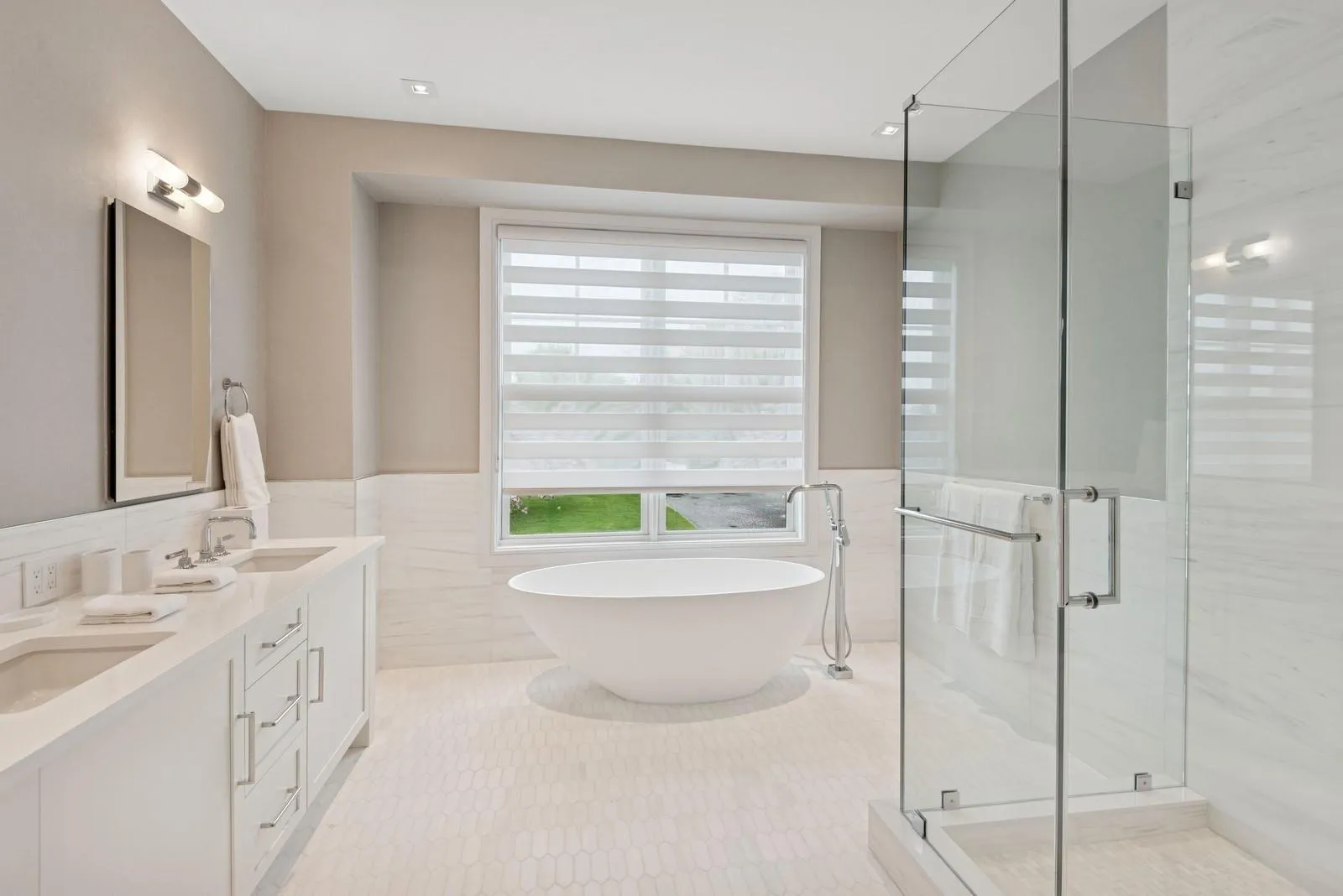 Bathroom with tile walls, a shower stall, a freestanding bath, tile patterned floors, and wainscoting Bathroom with tile walls, a shower stall, a freestanding bath, tile patterned floors, and wainscoting