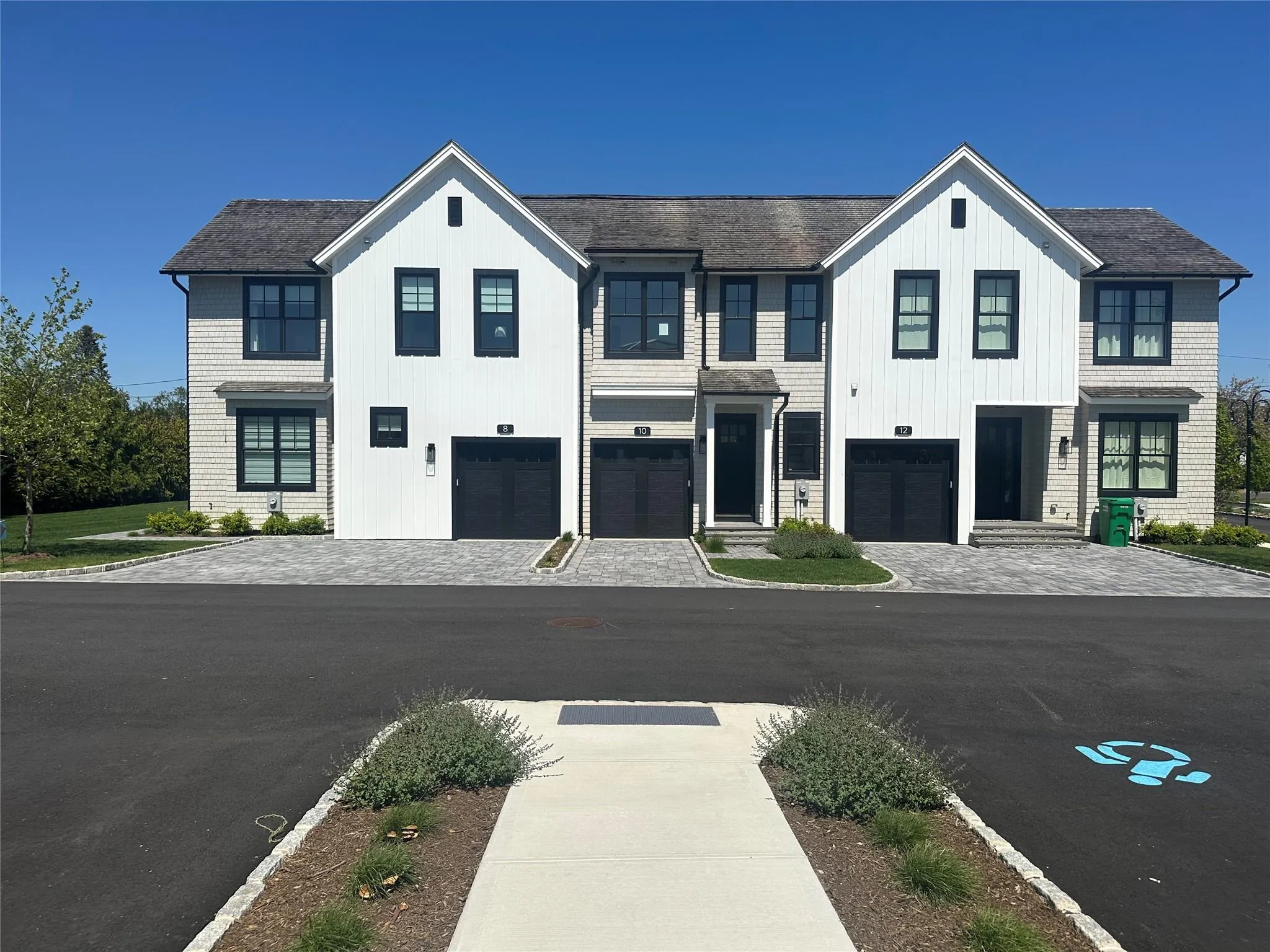 View of front of home with an attached garage and decorative driveway View of front of home with an attached garage and decorative driveway