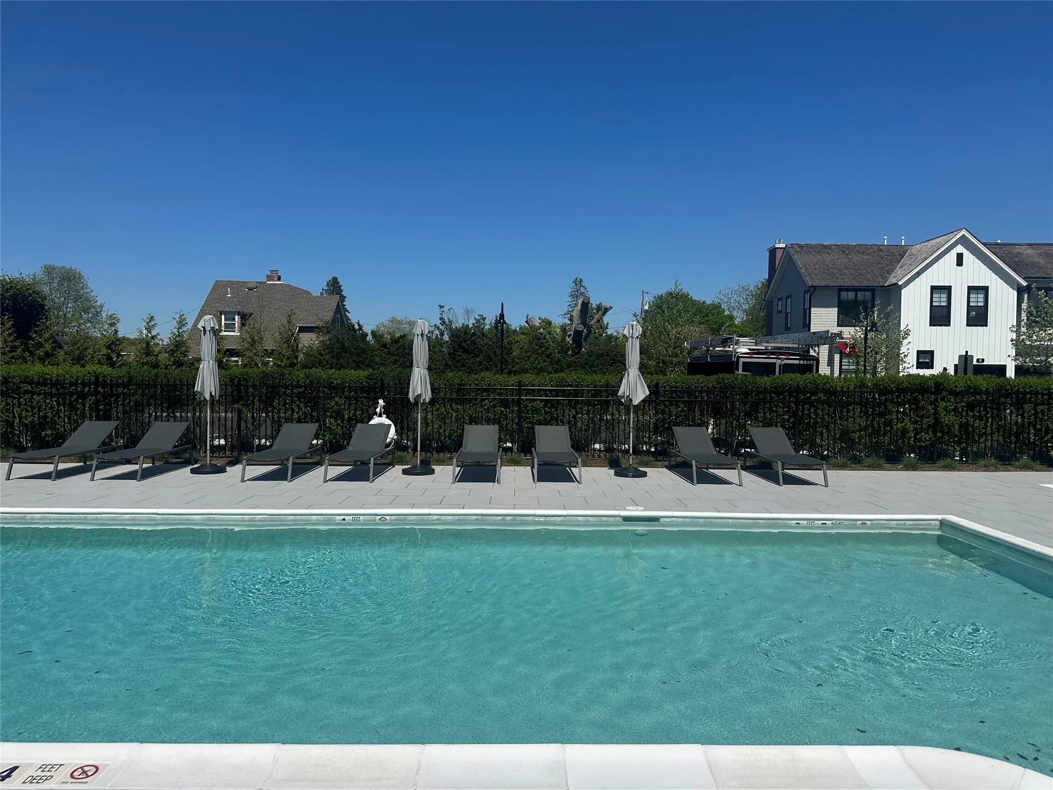 Community pool with fence and a patio Community pool with fence and a patio