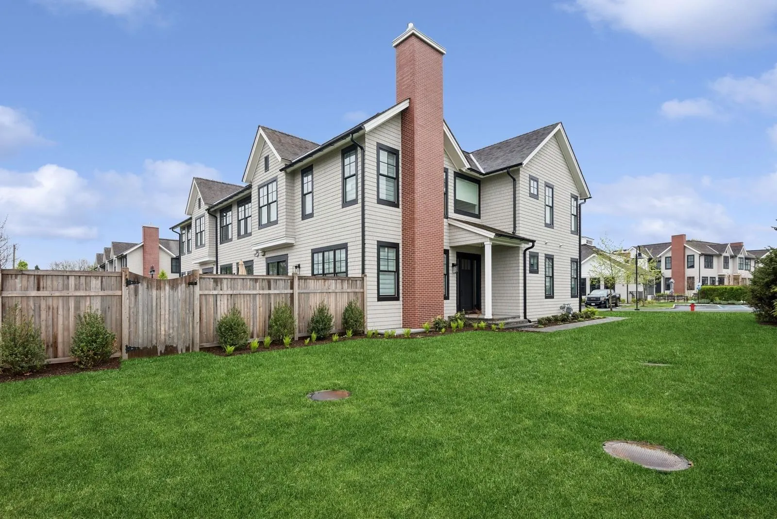Rear view of house featuring a residential view, a chimney, and a shingled roof Rear view of house featuring a residential view, a chimney, and a shingled roof