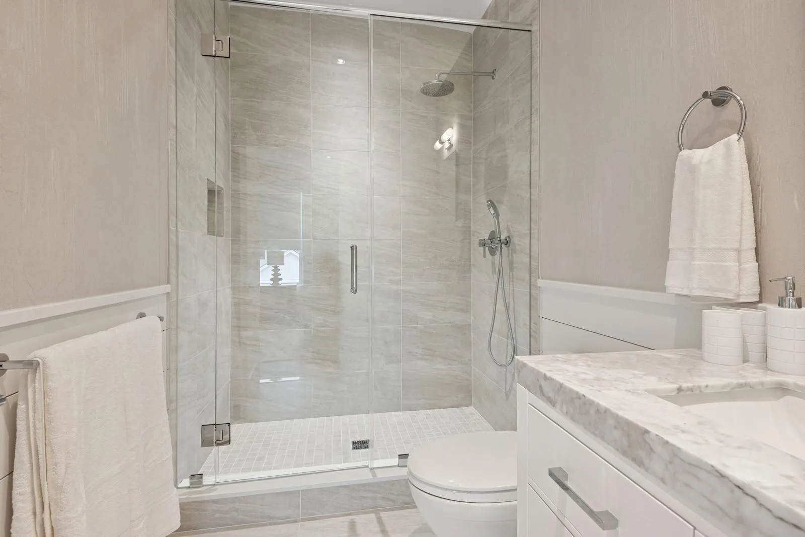 Bathroom with a shower stall, toilet, and vanity Bathroom with a shower stall, toilet, and vanity