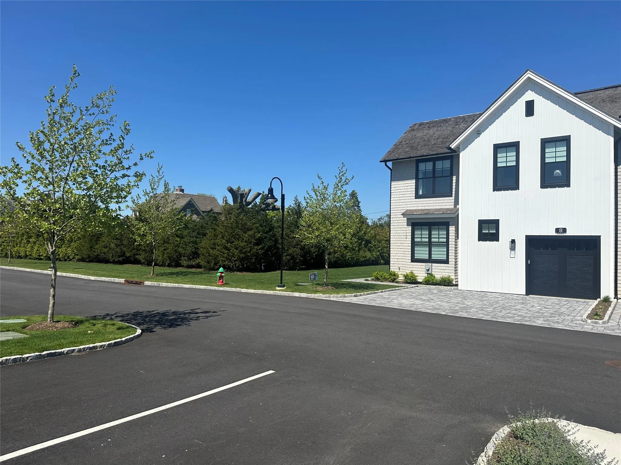 View of asphalt street with street lighting and curbs View of asphalt street with street lighting and curbs