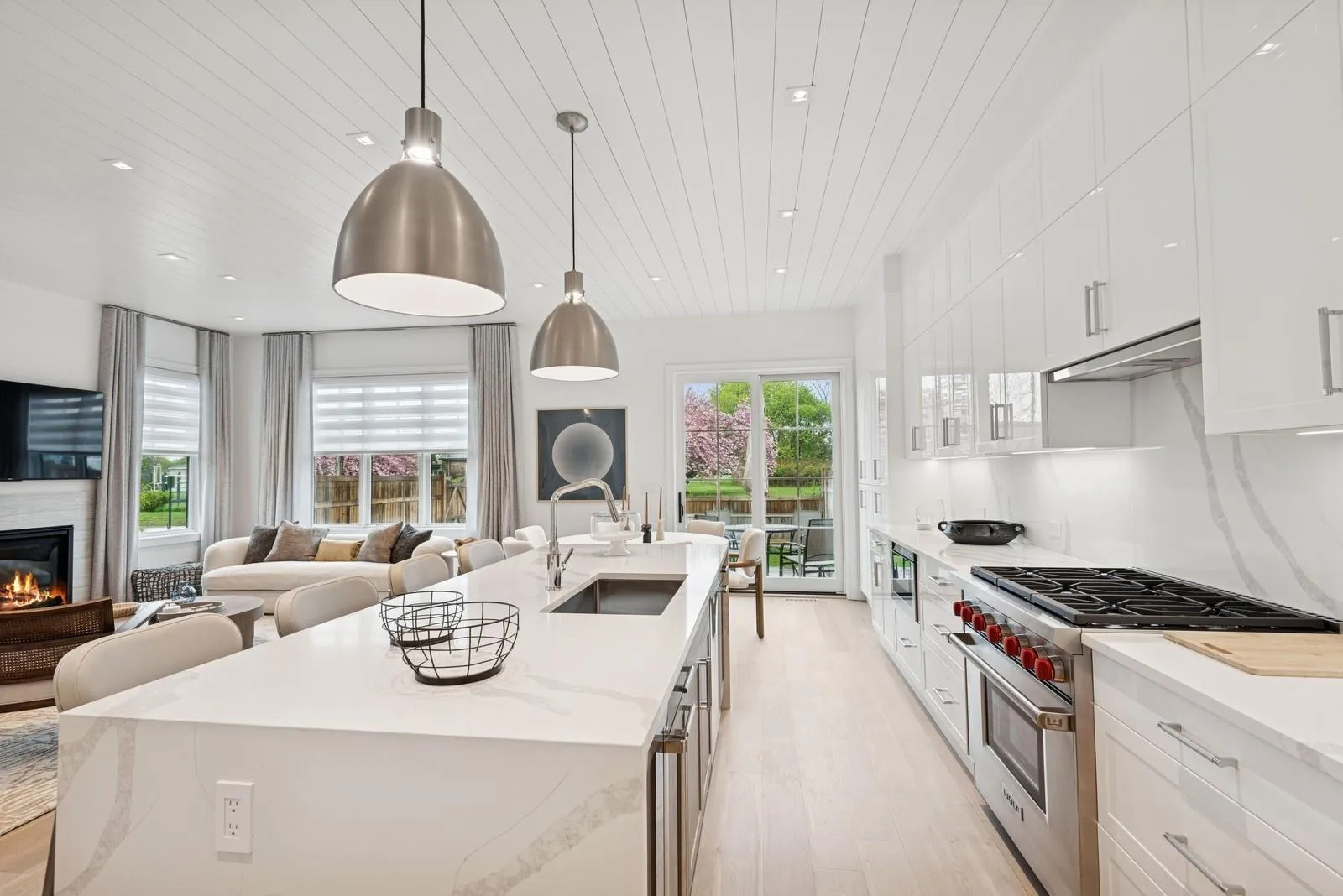 Kitchen with high end range, a sink, light wood-style floors, a center island with sink, and open floor plan Kitchen with high end range, a sink, light wood-style floors, a center island with sink, and open floor plan