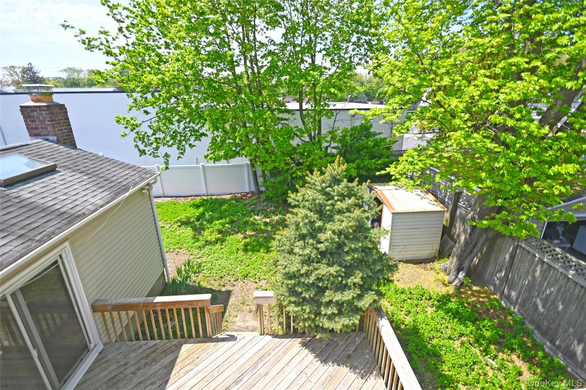 Wooden deck featuring a storage unit, an outdoor structure, and a fenced backyard Wooden deck featuring a storage unit, an outdoor structure, and a fenced backyard